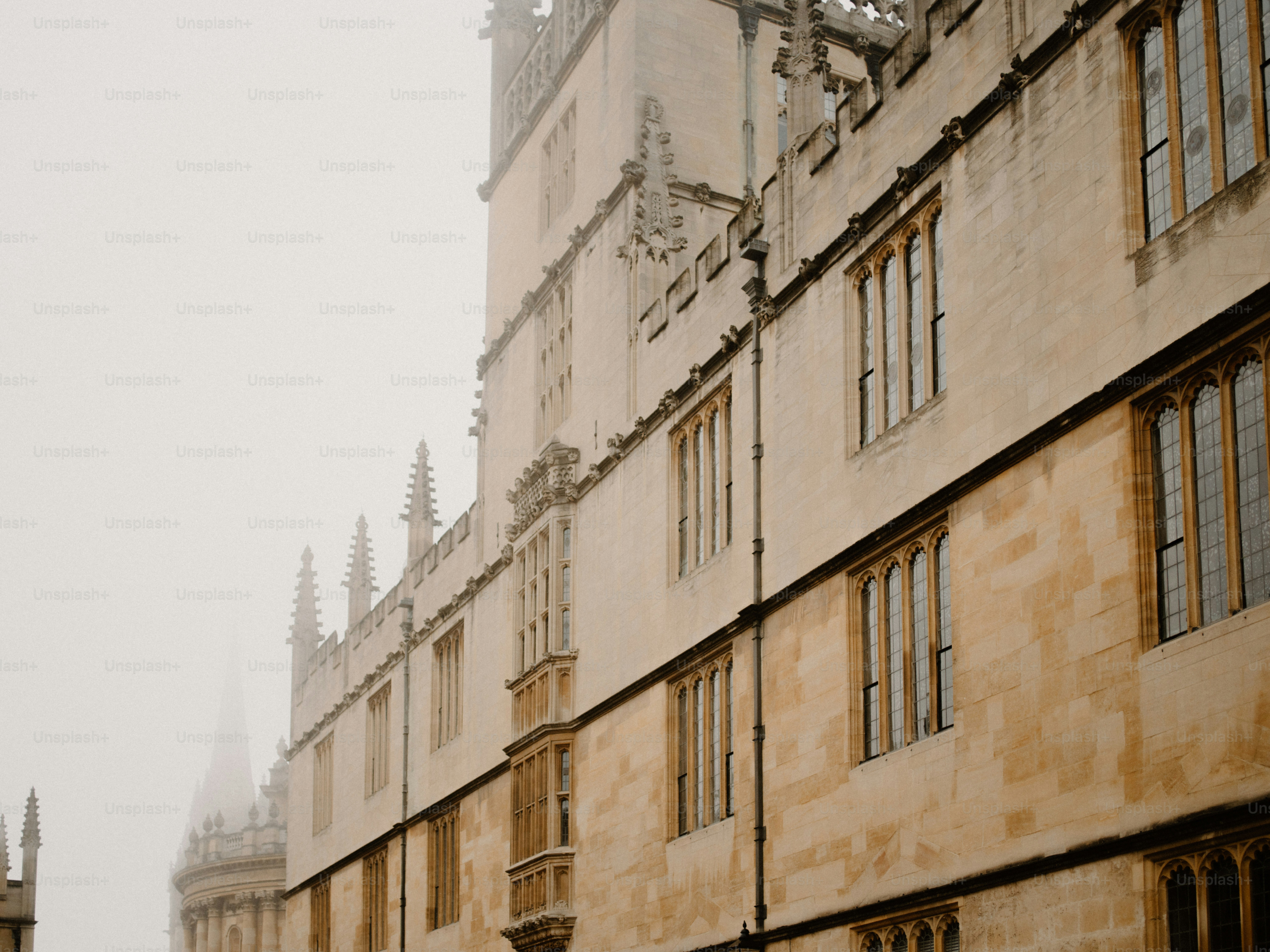 Historic stone building facade shrouded in fog.