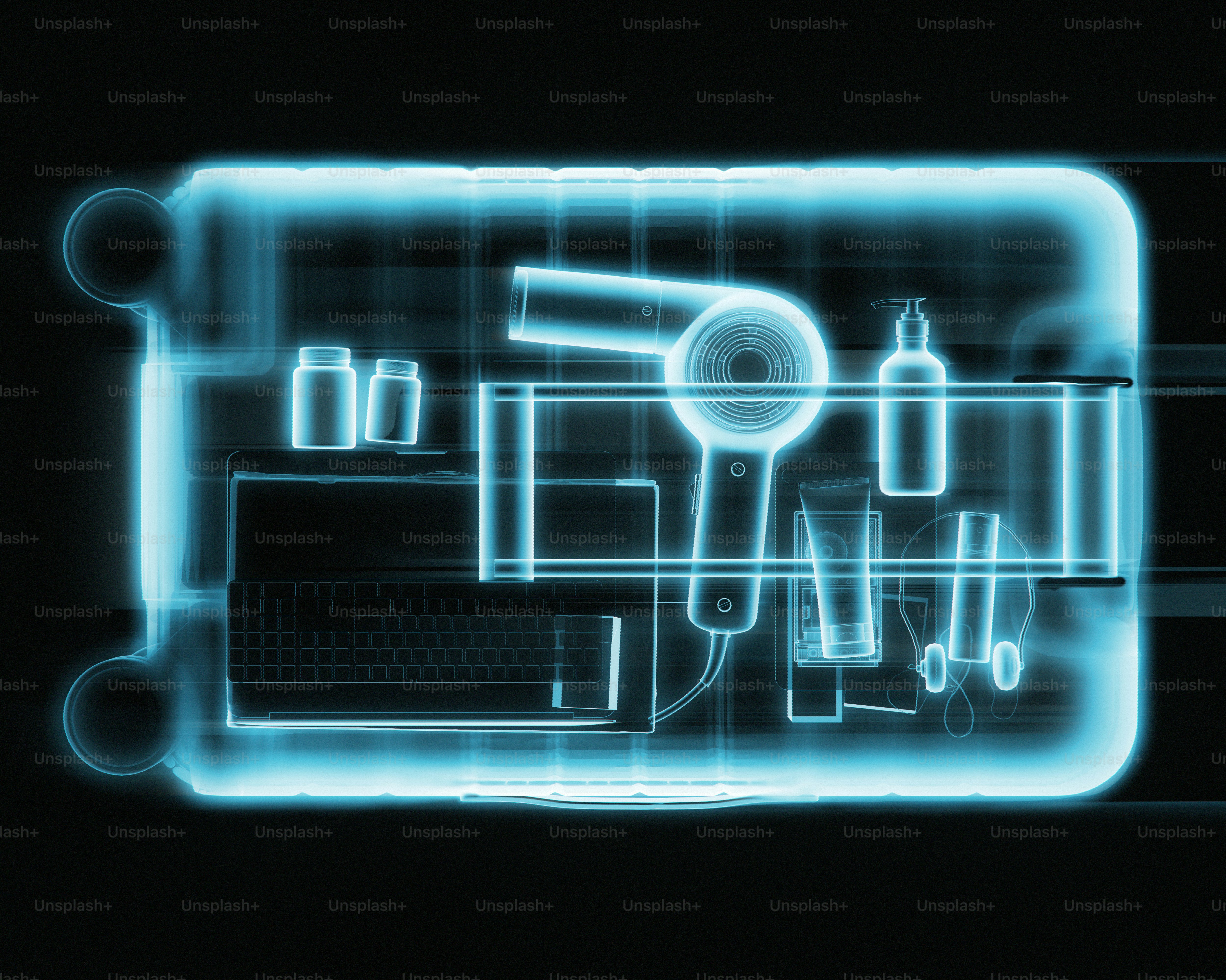 Contents of a suitcase with toiletries and electronics