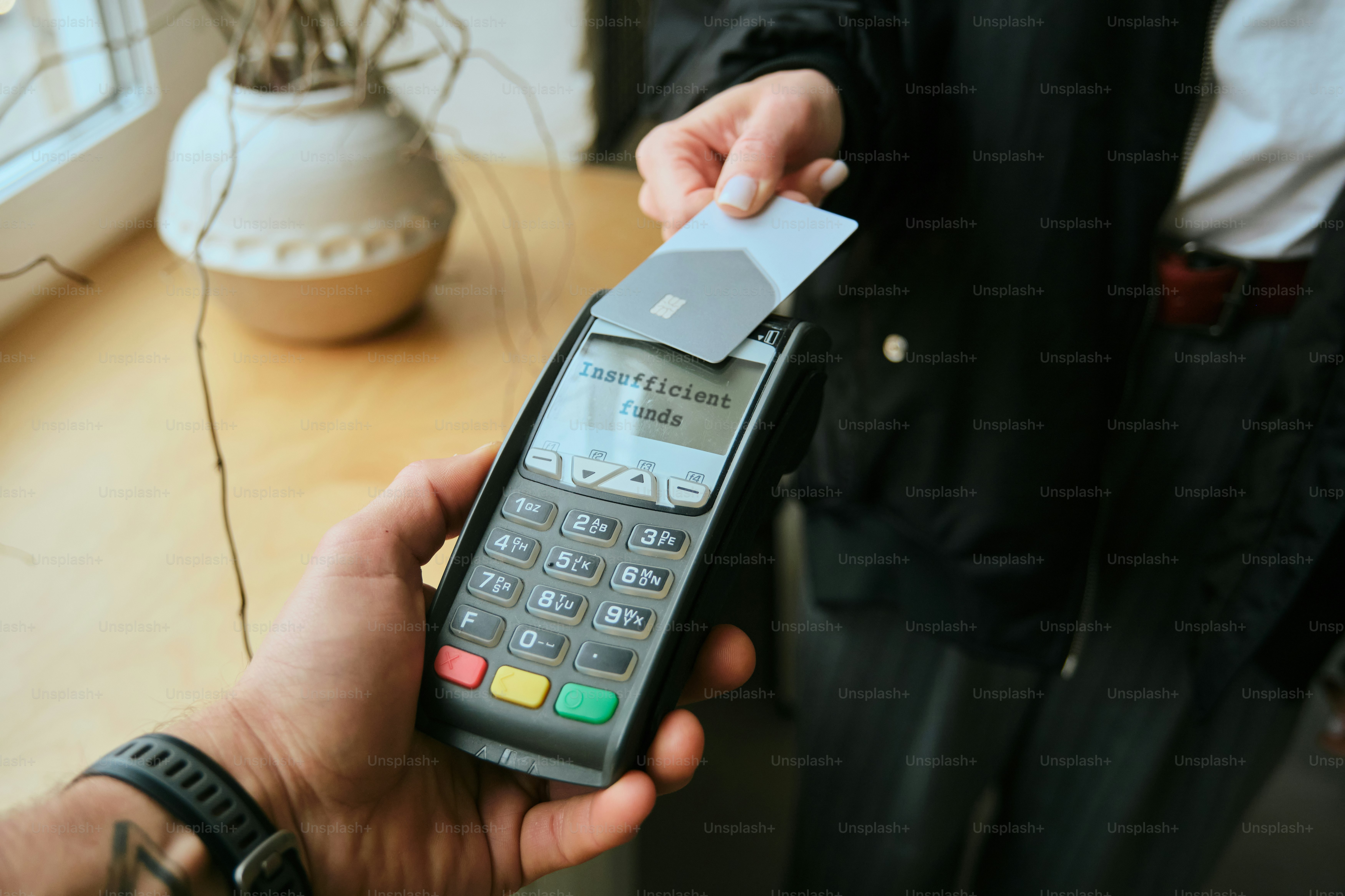 Customer paying with contactless card at payment terminal