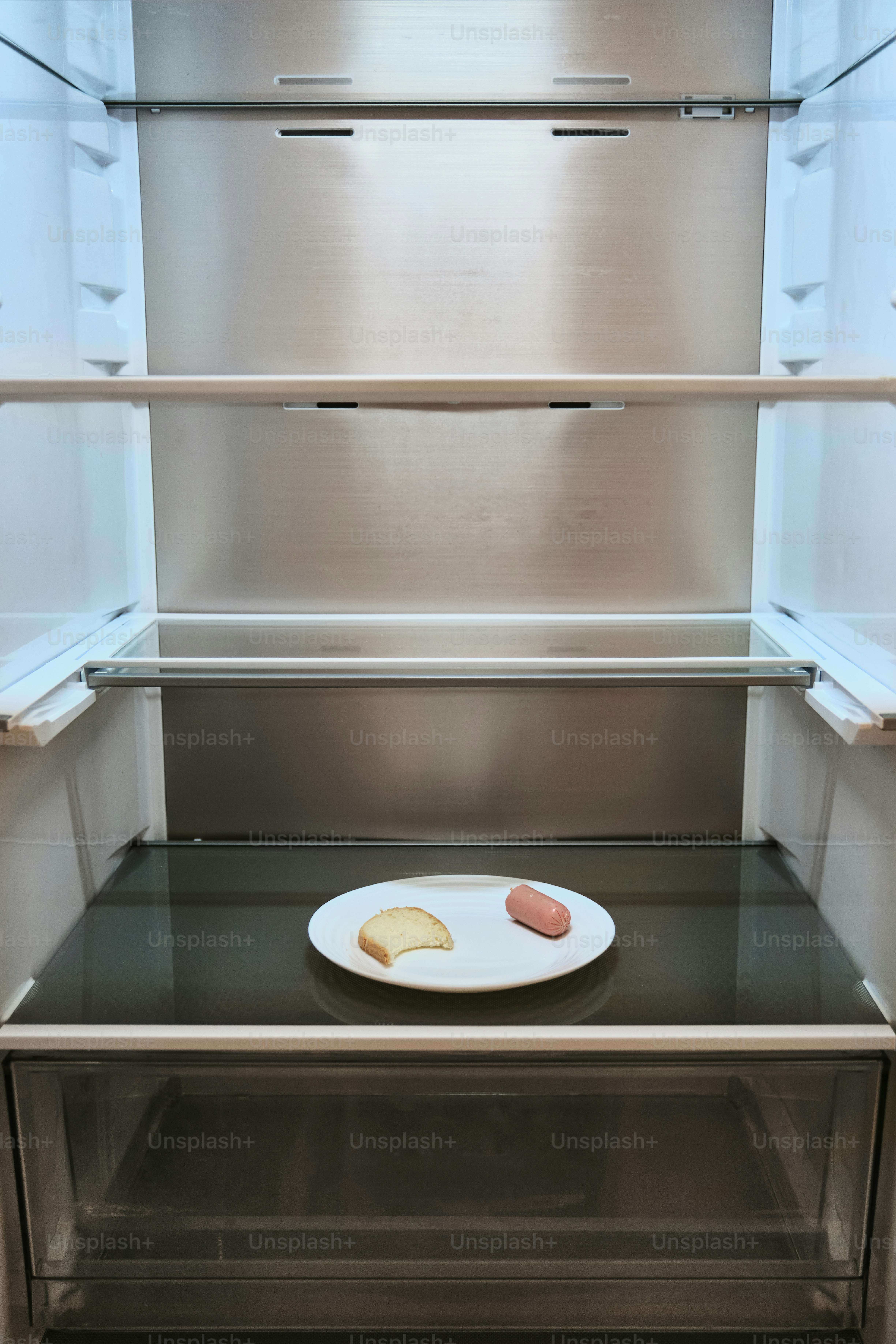 A single slice of bread and sausage on a plate.