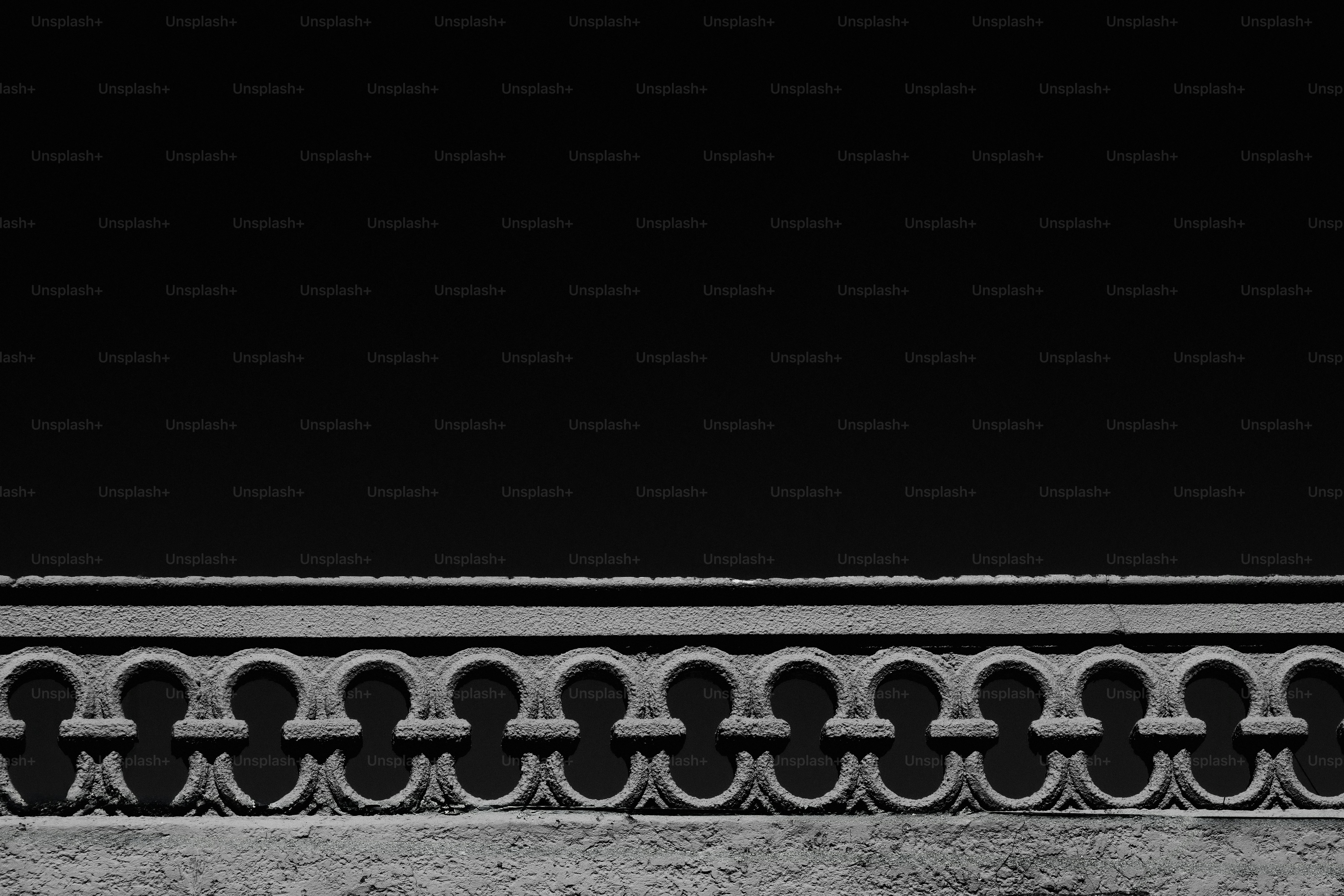 Ornate stone balustrade against a dark sky.