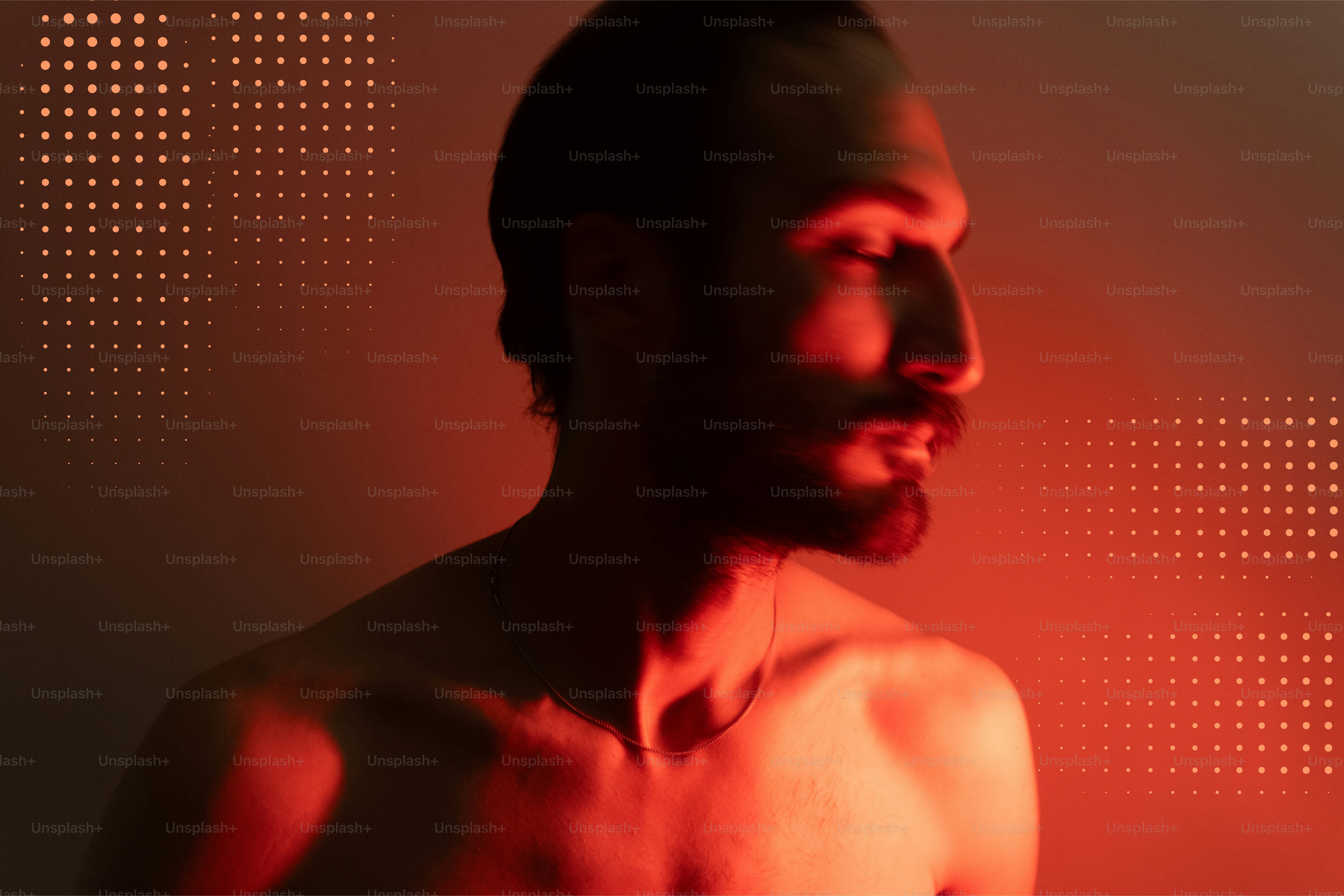 Man with beard in red light with dotted pattern