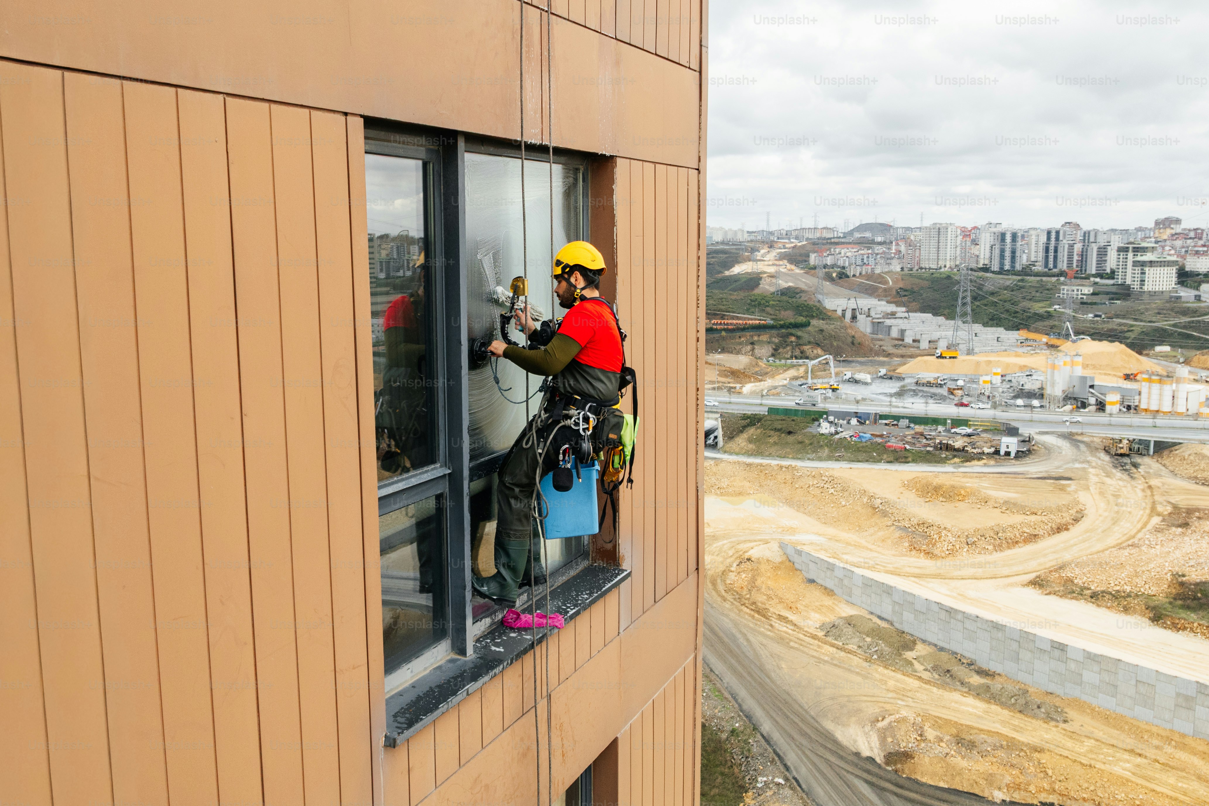 Window cleaner working on high-rise building exterior photo – Rope ...
