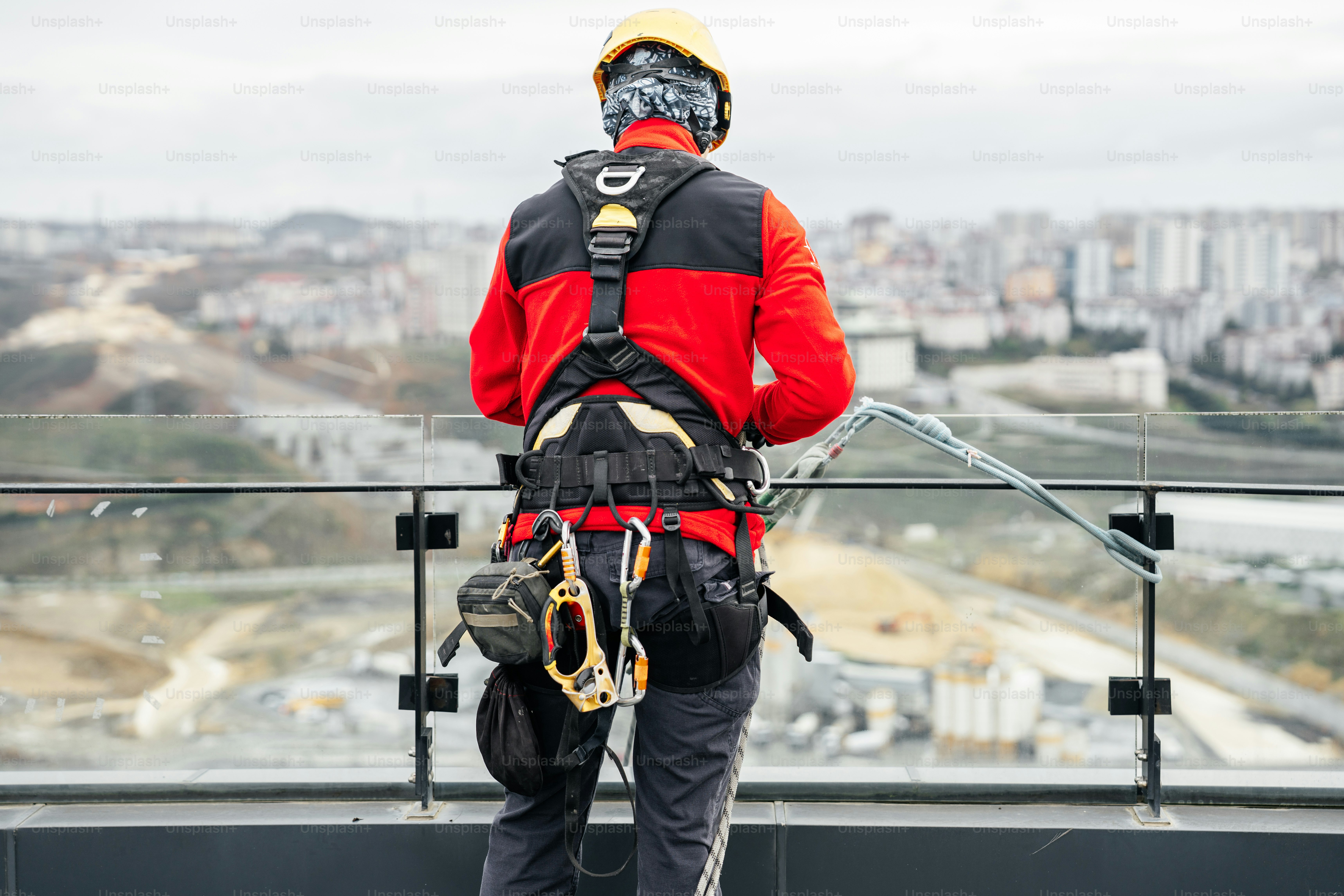 Safety comes first — every climber tests the ropes, carabiners, and anchors under supervision before the cleaning begins.