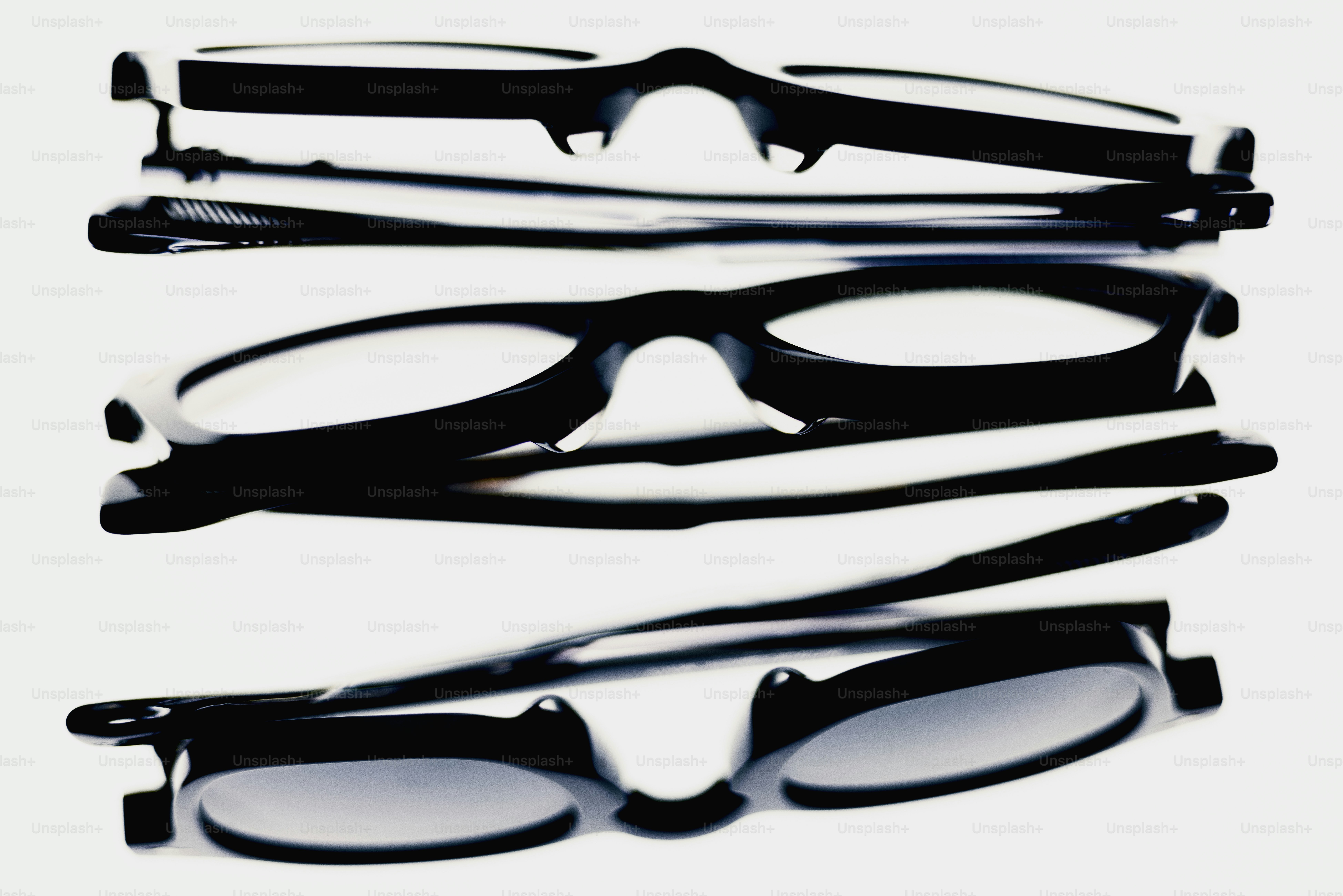 Three pairs of black eyeglasses stacked