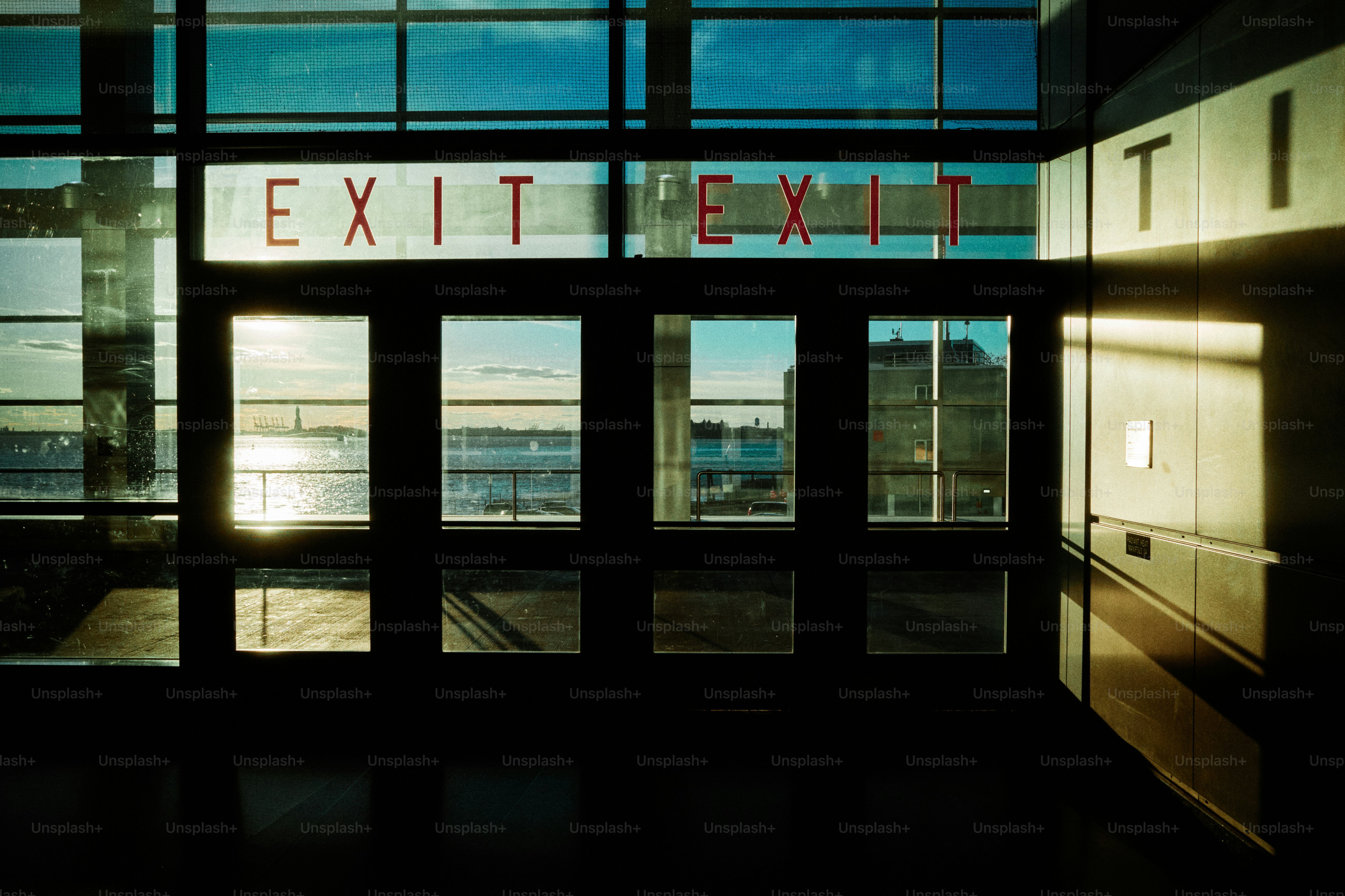 Exit signs on glass doors looking outside