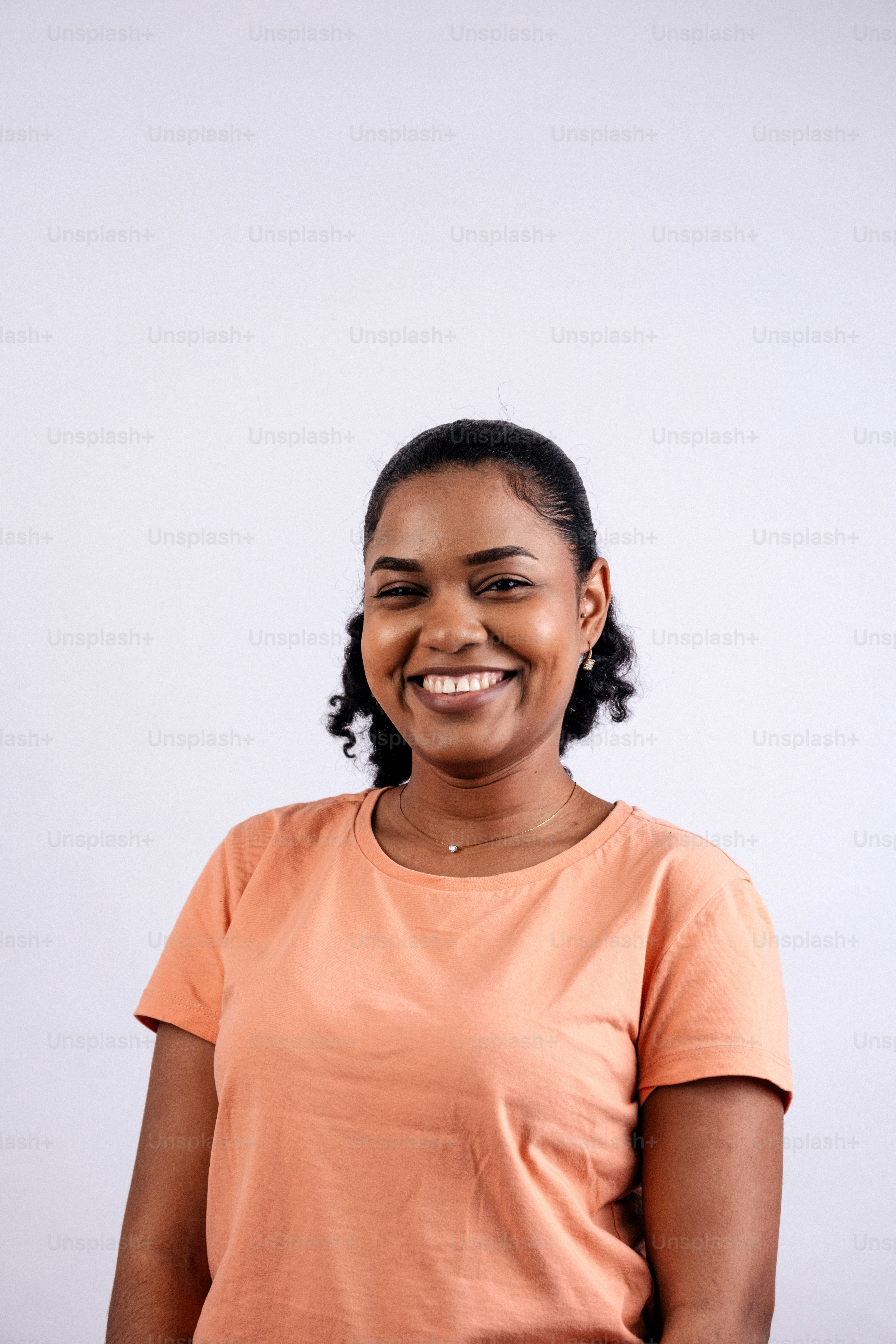 A smiling woman in an orange t-shirt