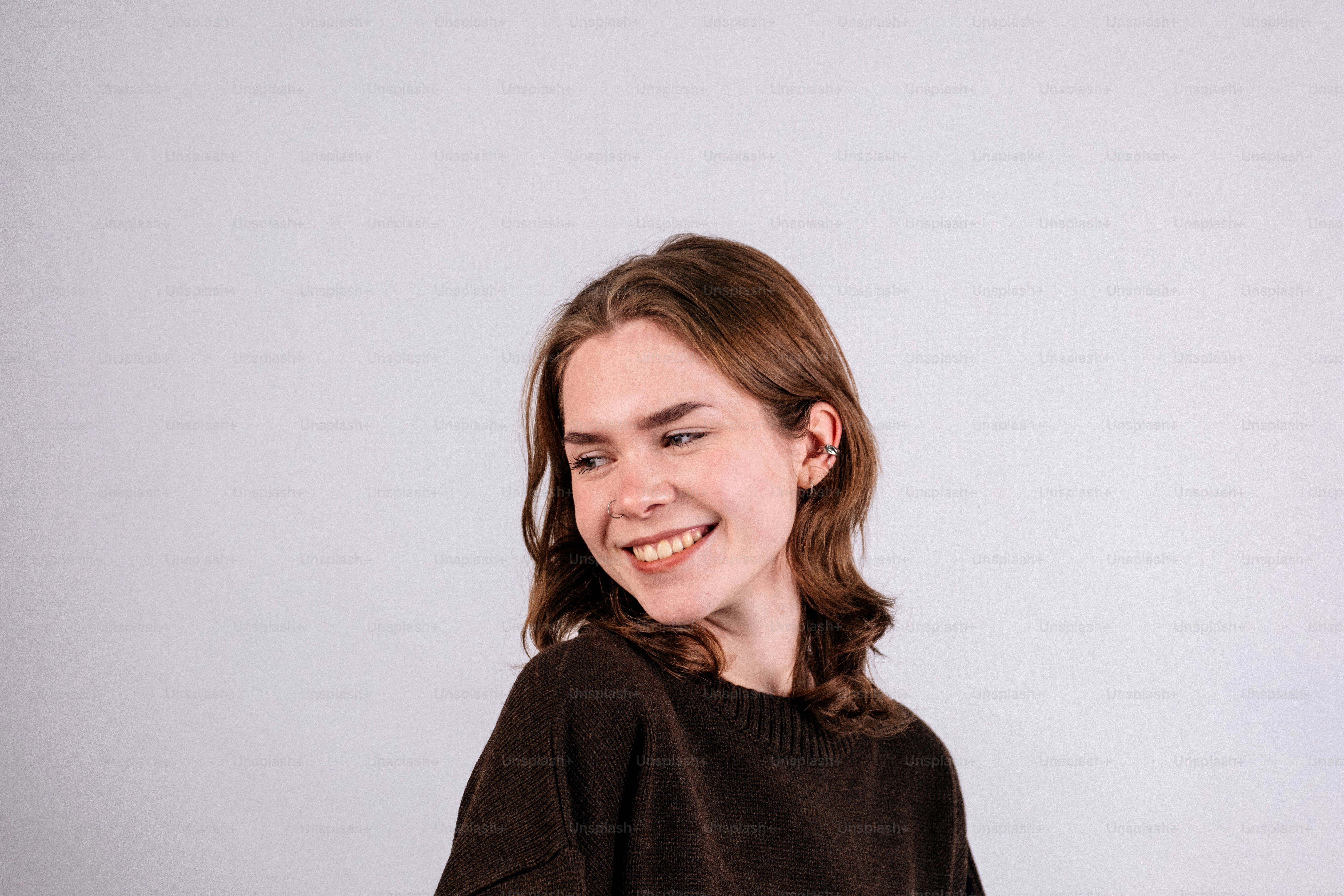 A young woman with brown hair smiles.