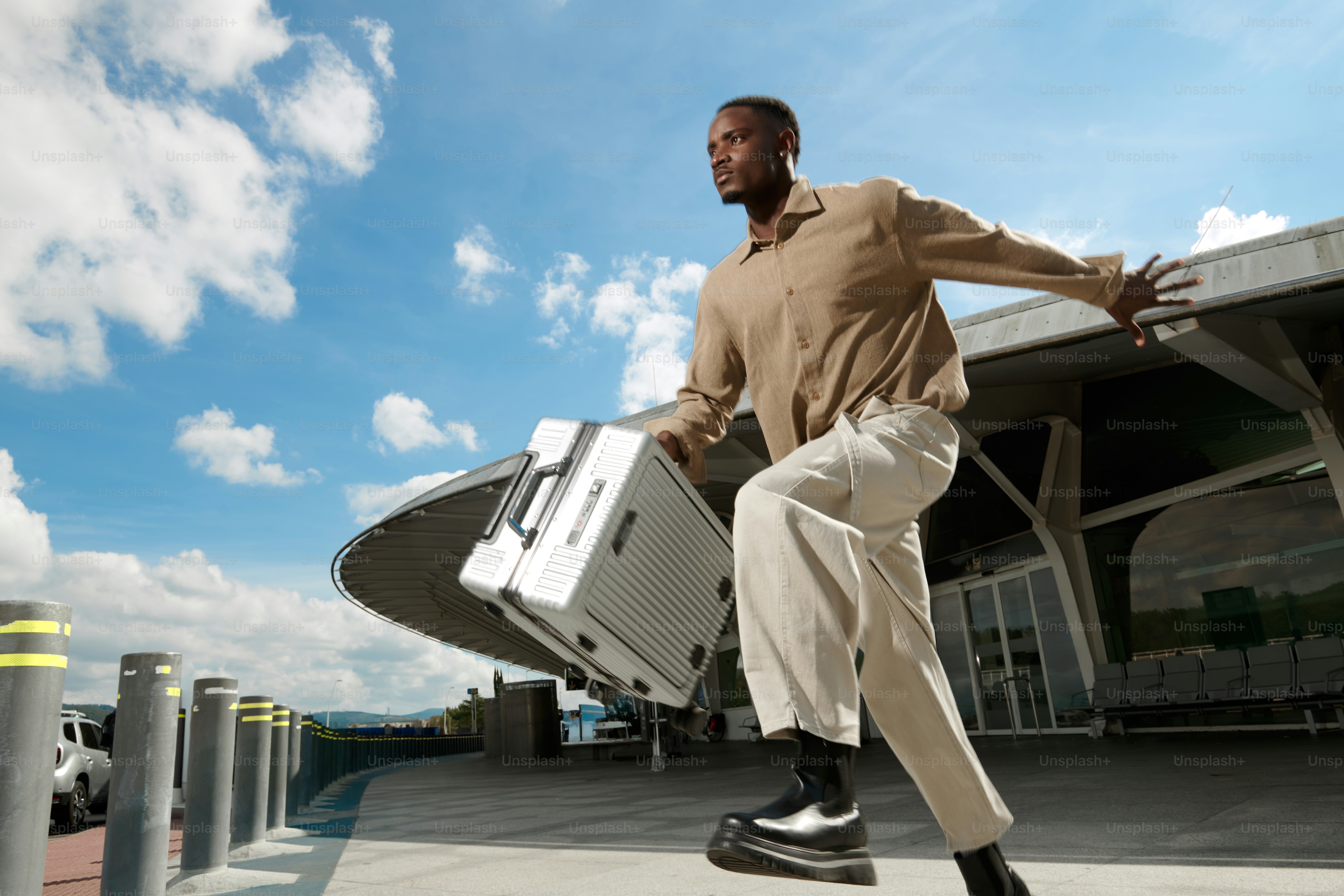 Man running with luggage at airport entrance