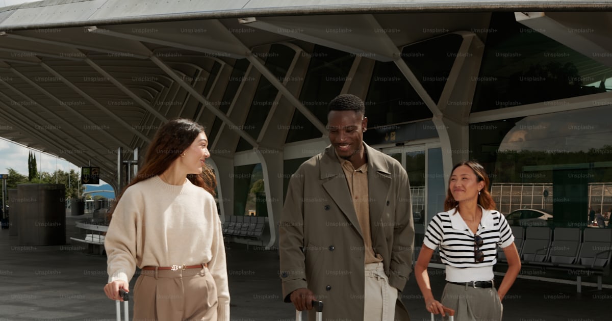 Three people with luggage outside a modern building photo – Travel ...