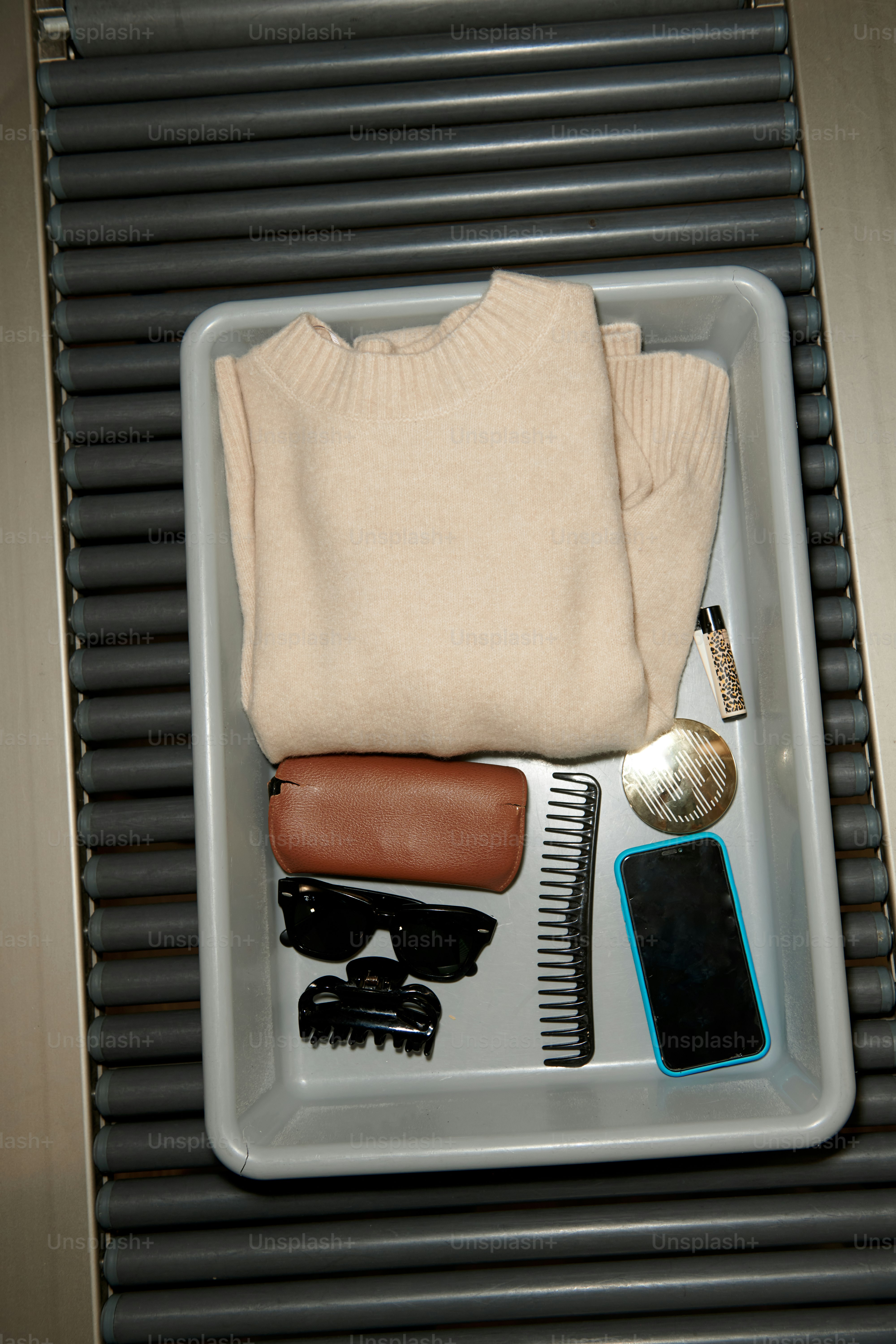 Items in a security tray on a conveyor belt.
