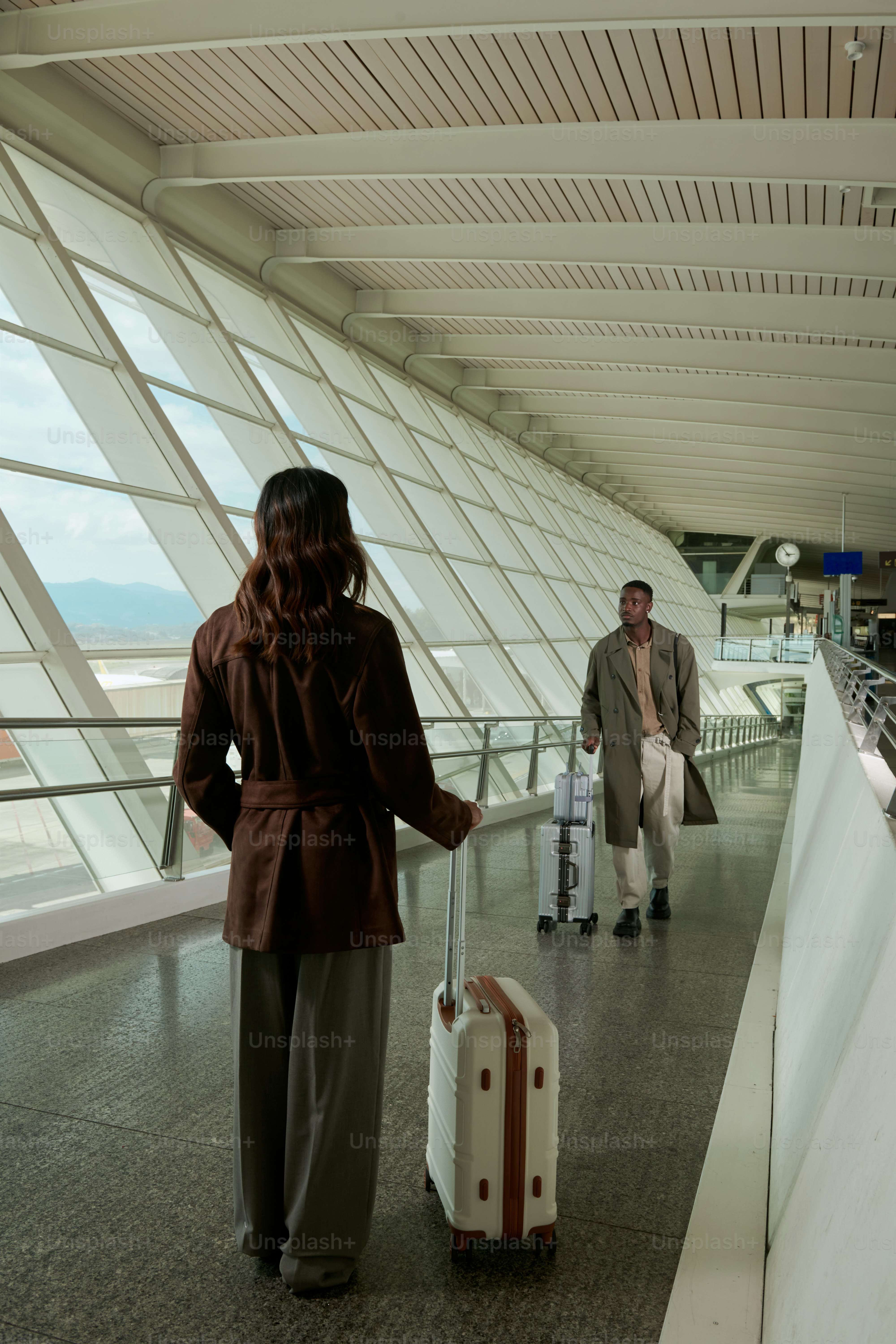 Couple walking with luggage in airport terminal photo – Travel Image on ...