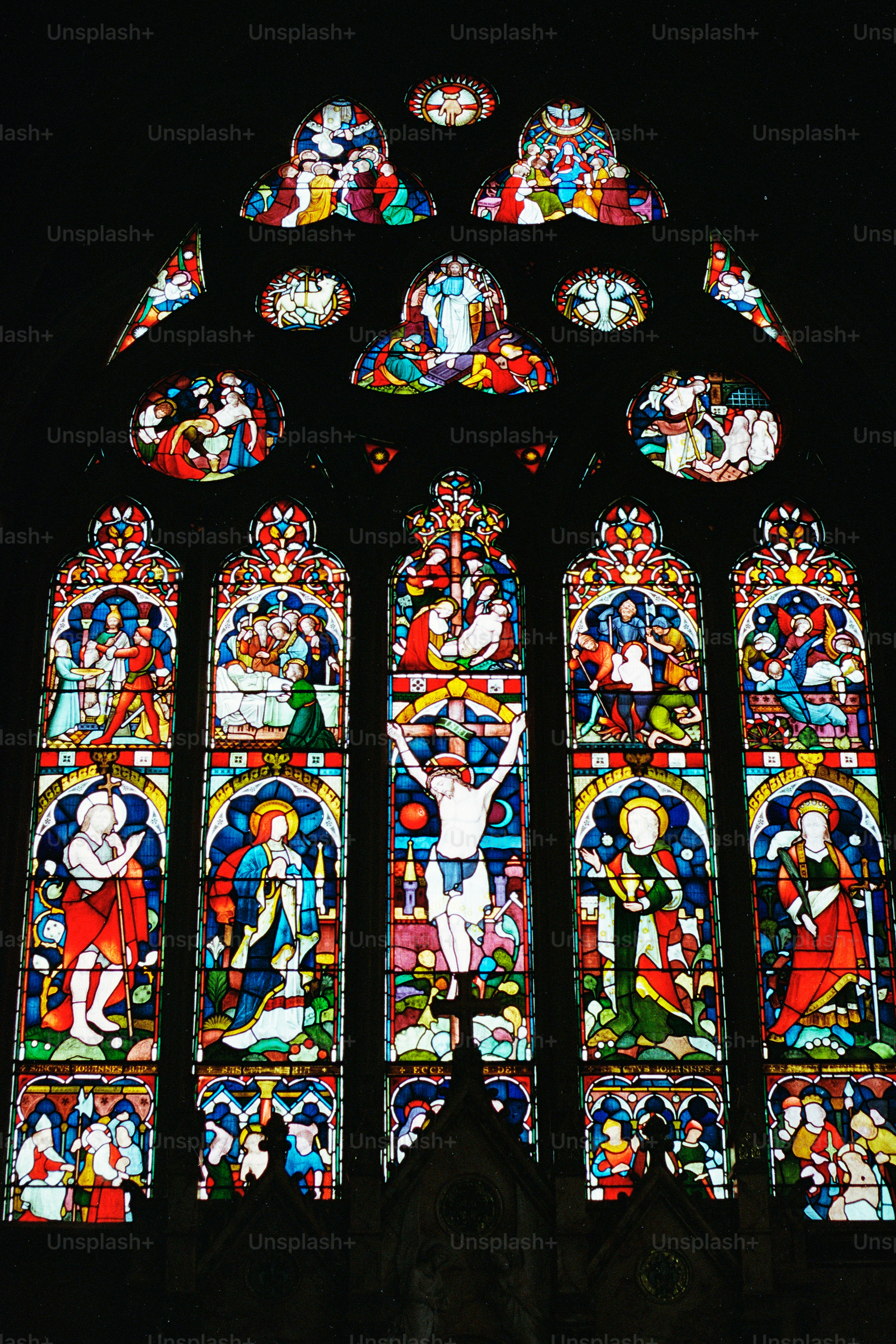 Intricate stained glass window depicting religious scenes
