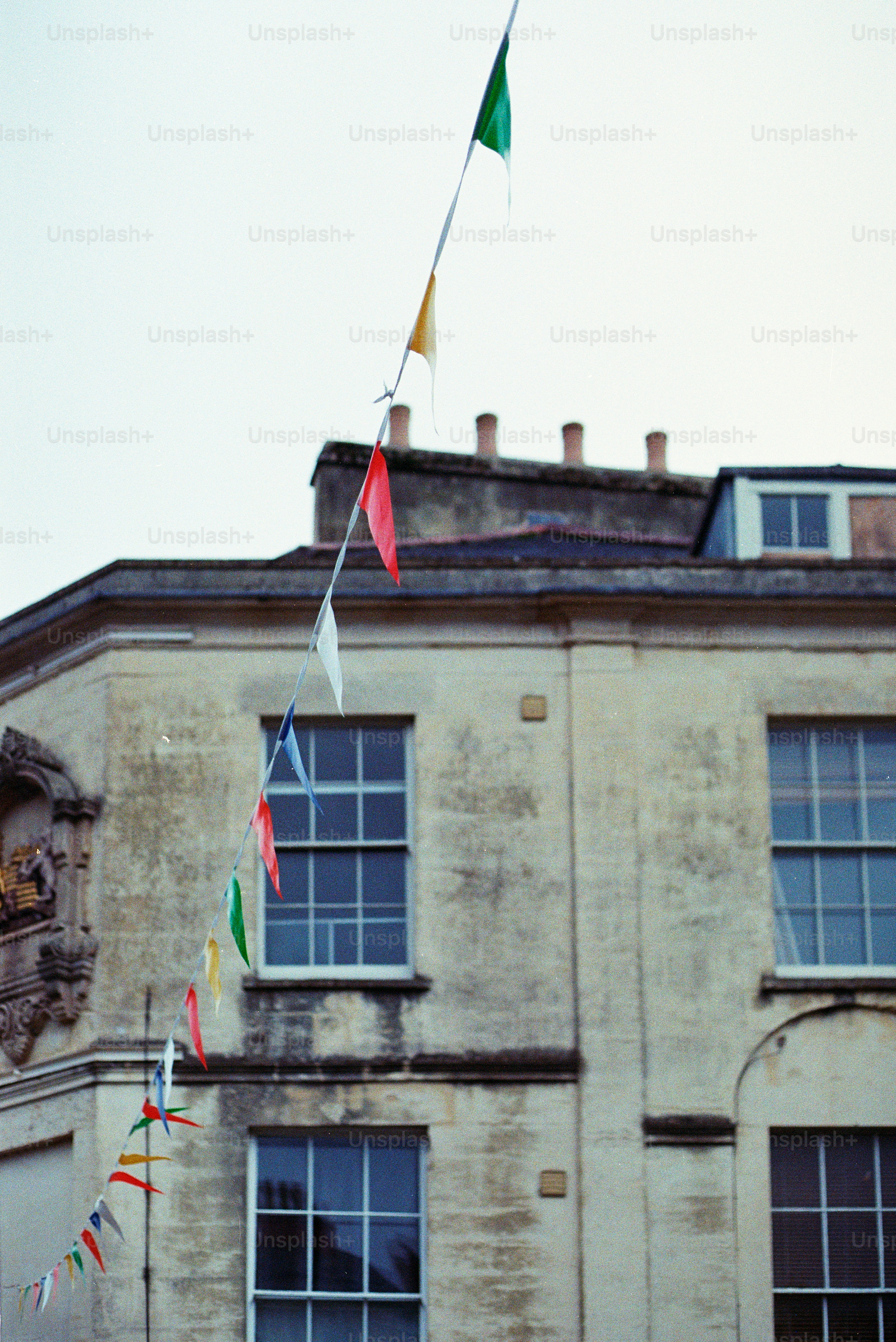 Colorful bunting flags strung across building facade