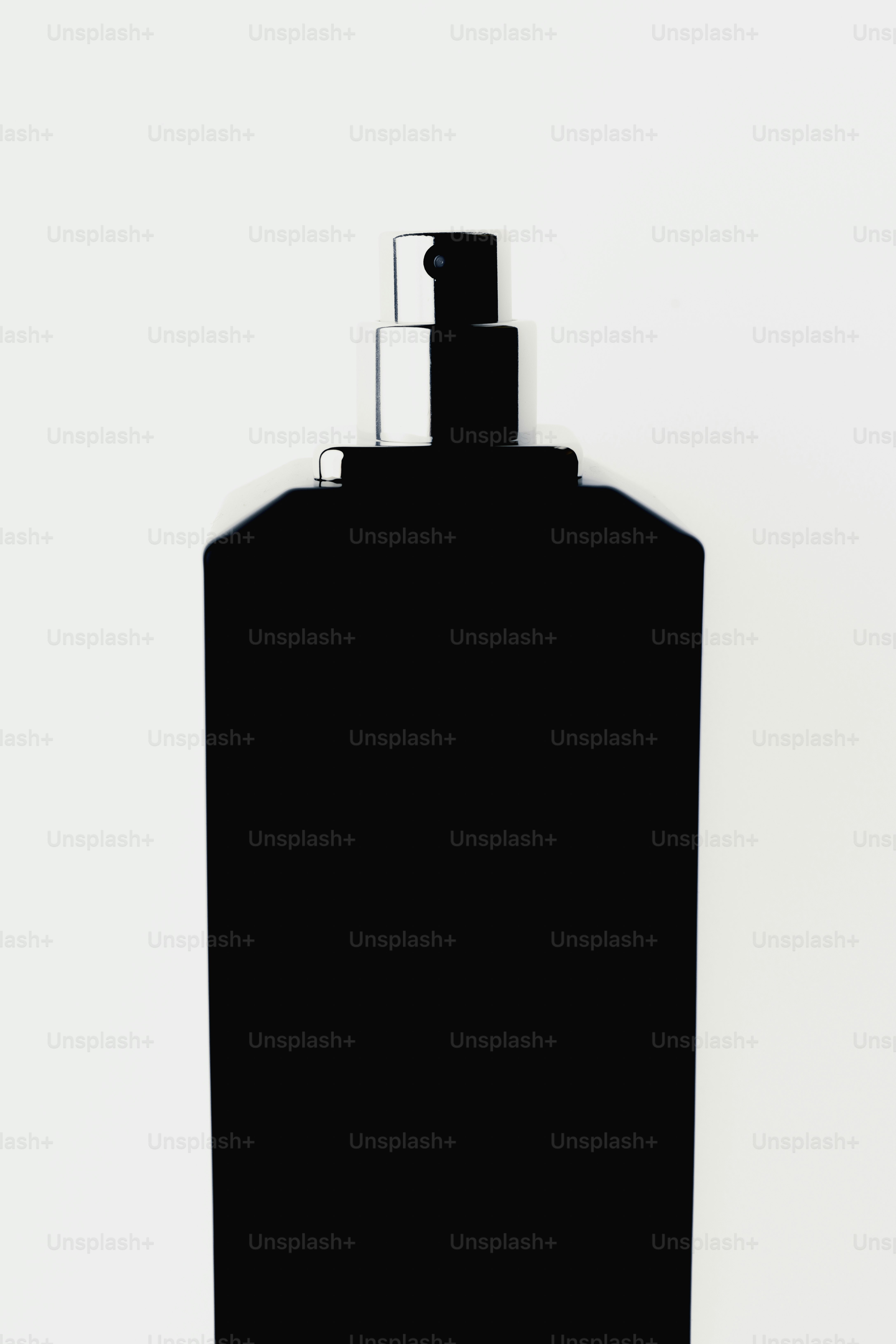 A black perfume bottle with a silver spray nozzle.