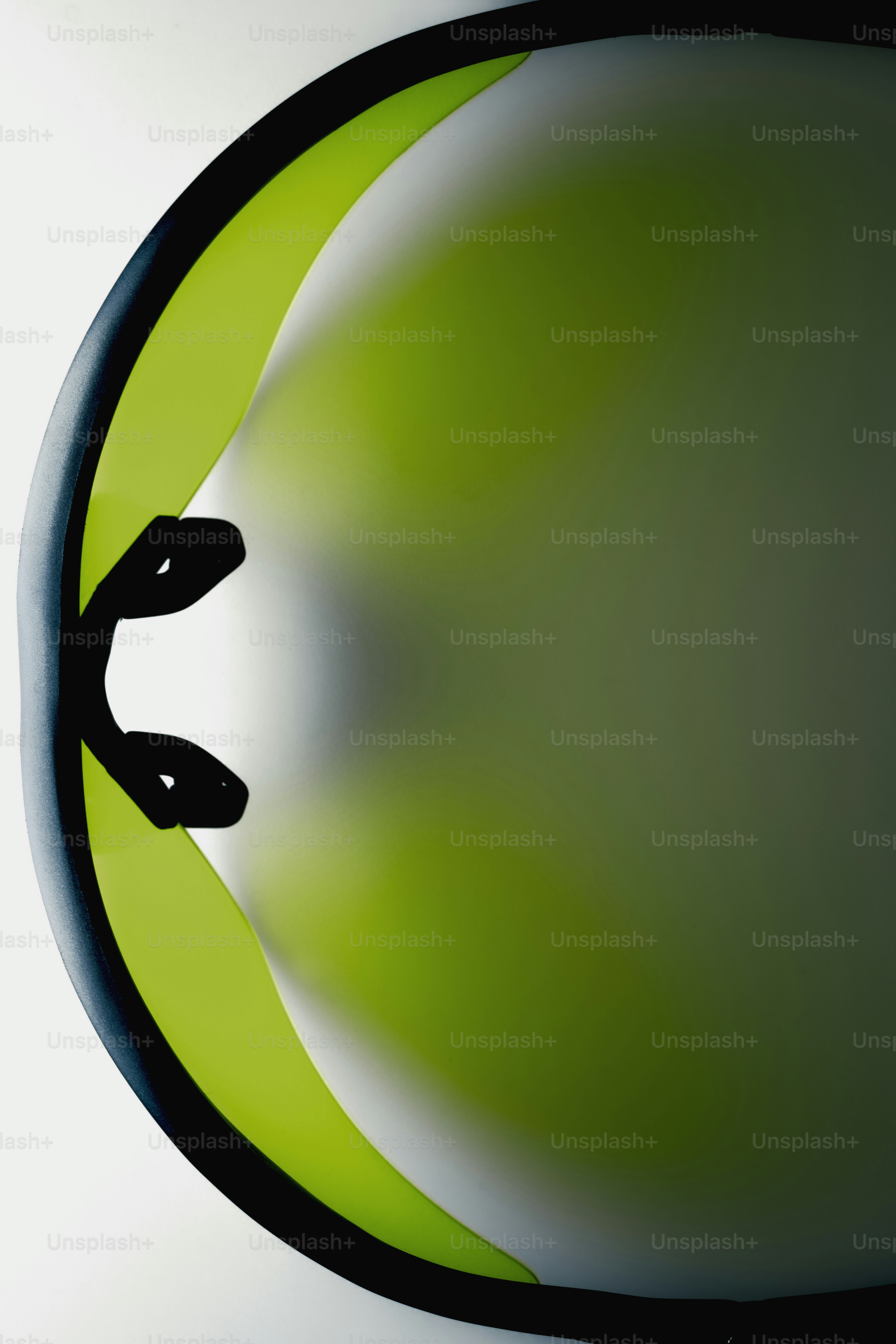 Abstract green and black curved shapes with two black dots.