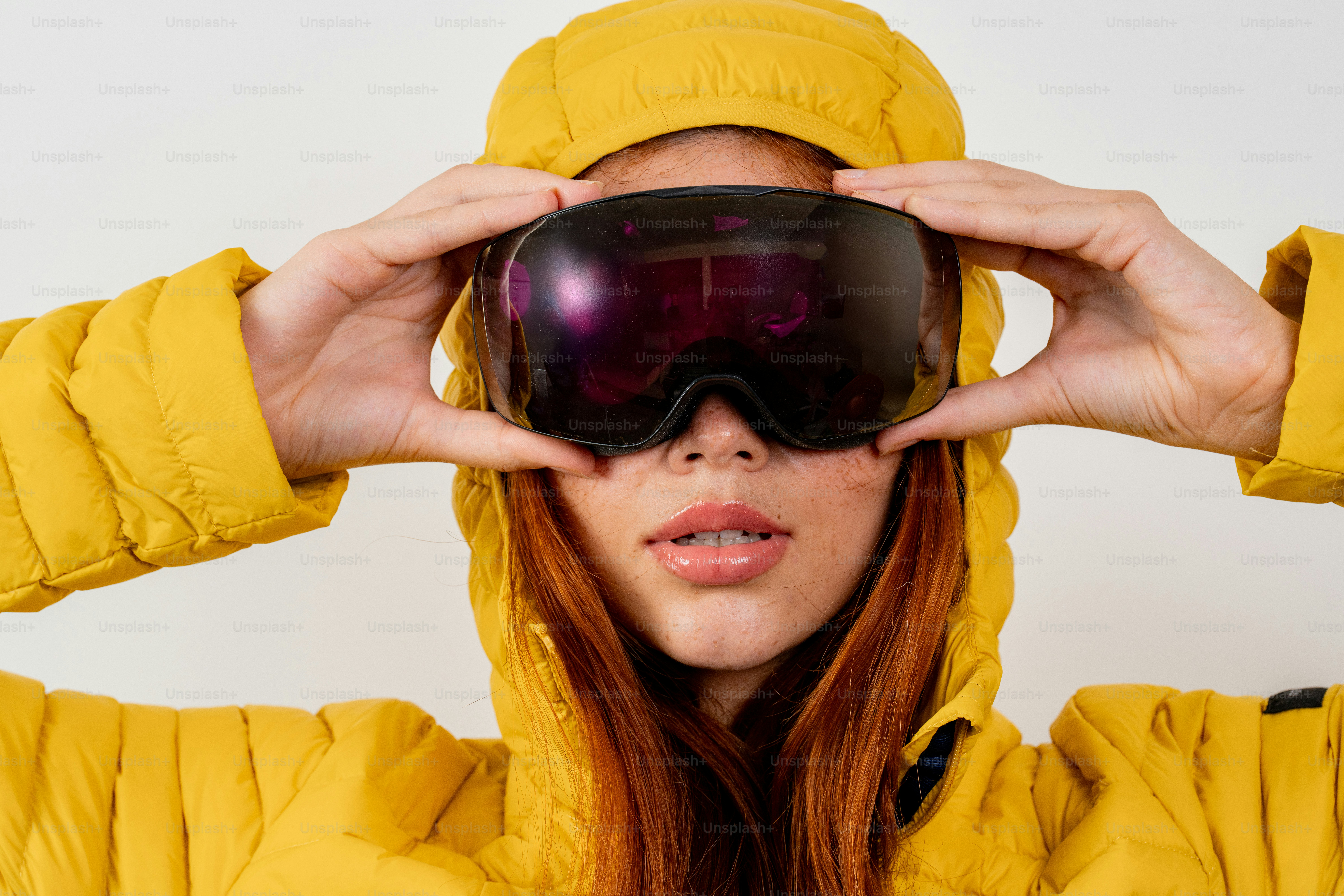 Woman in yellow puffer jacket and ski goggles photo – Fashion Image on ...
