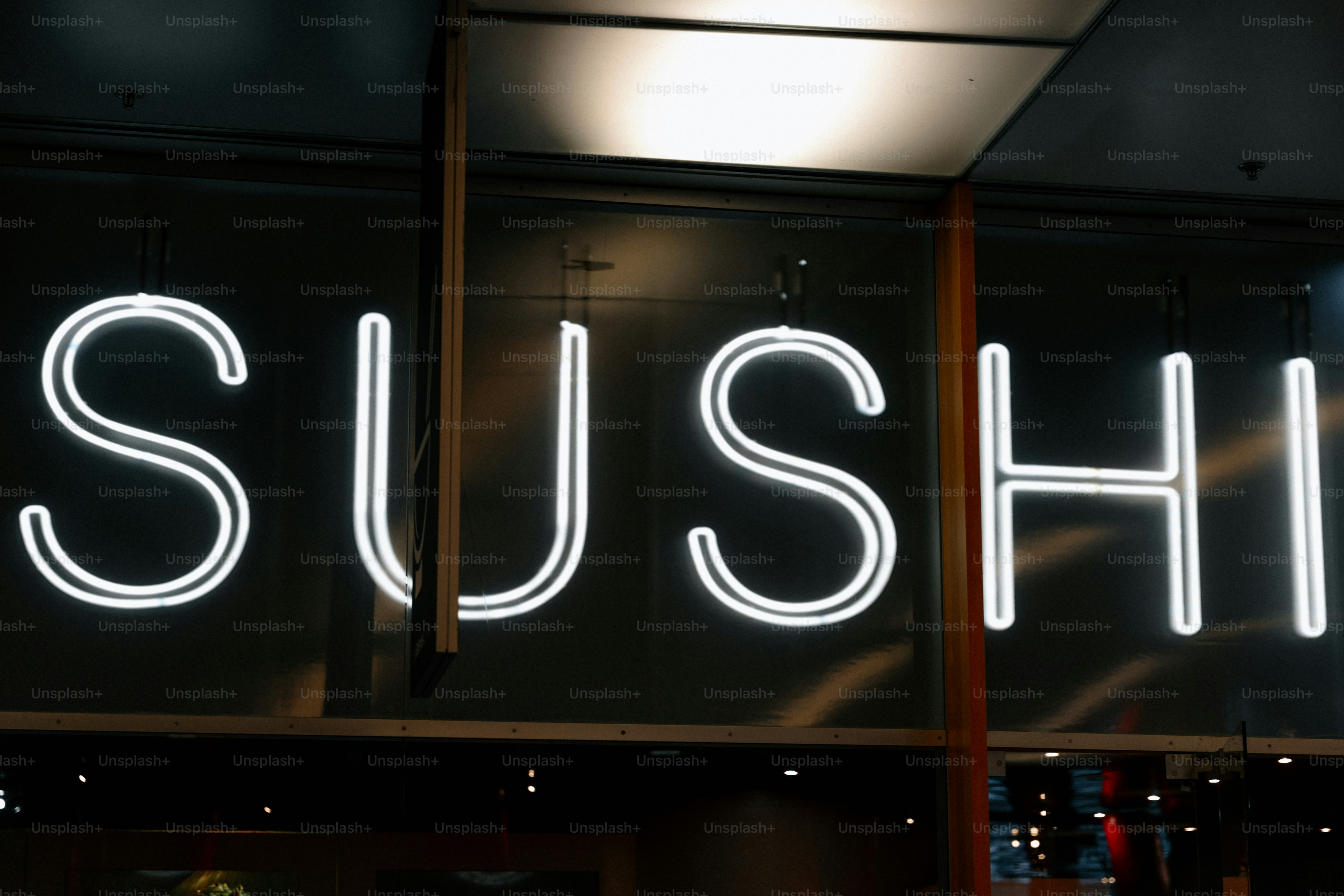 White neon sign spelling out sushi