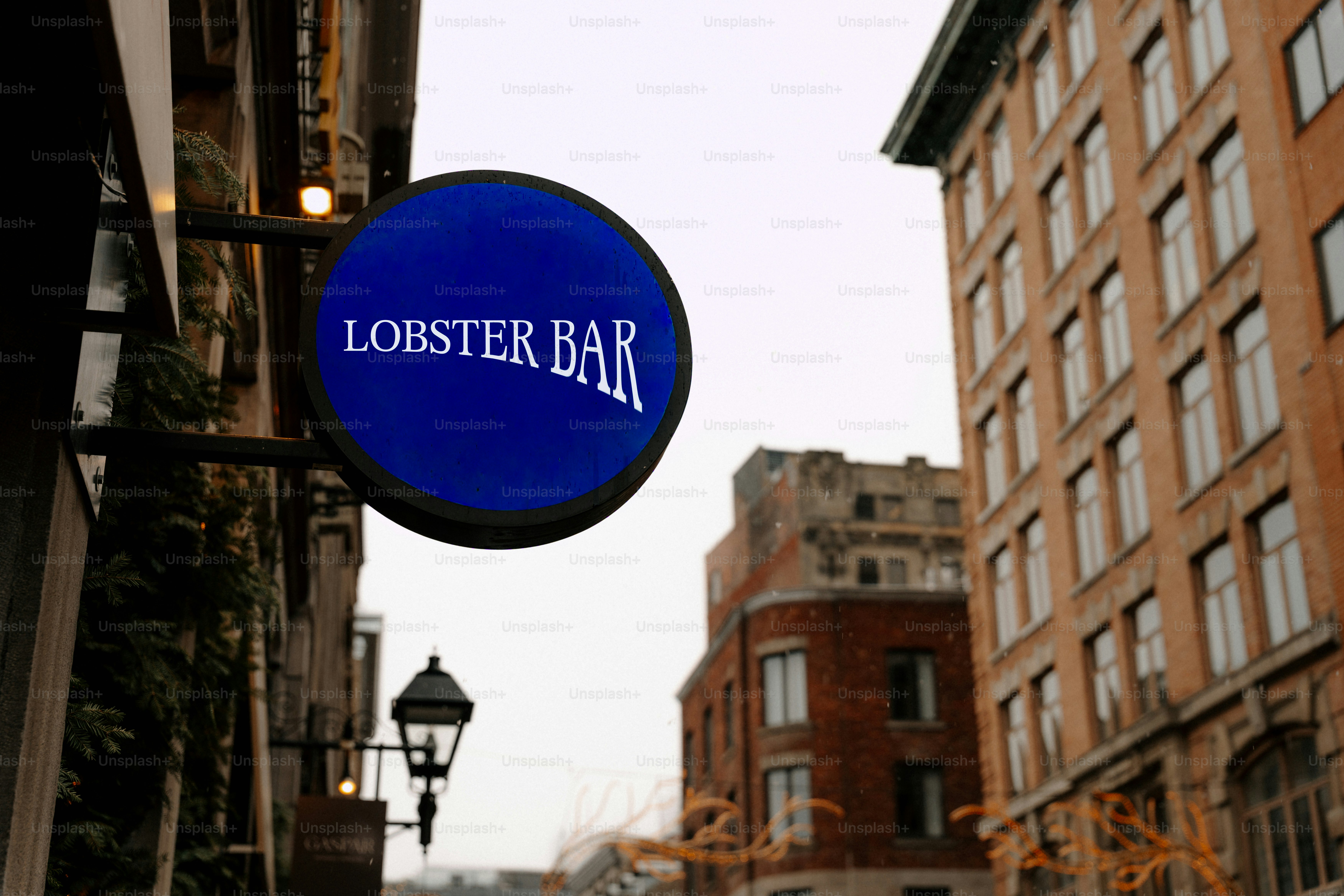 Blue sign for lobster bar on a city street