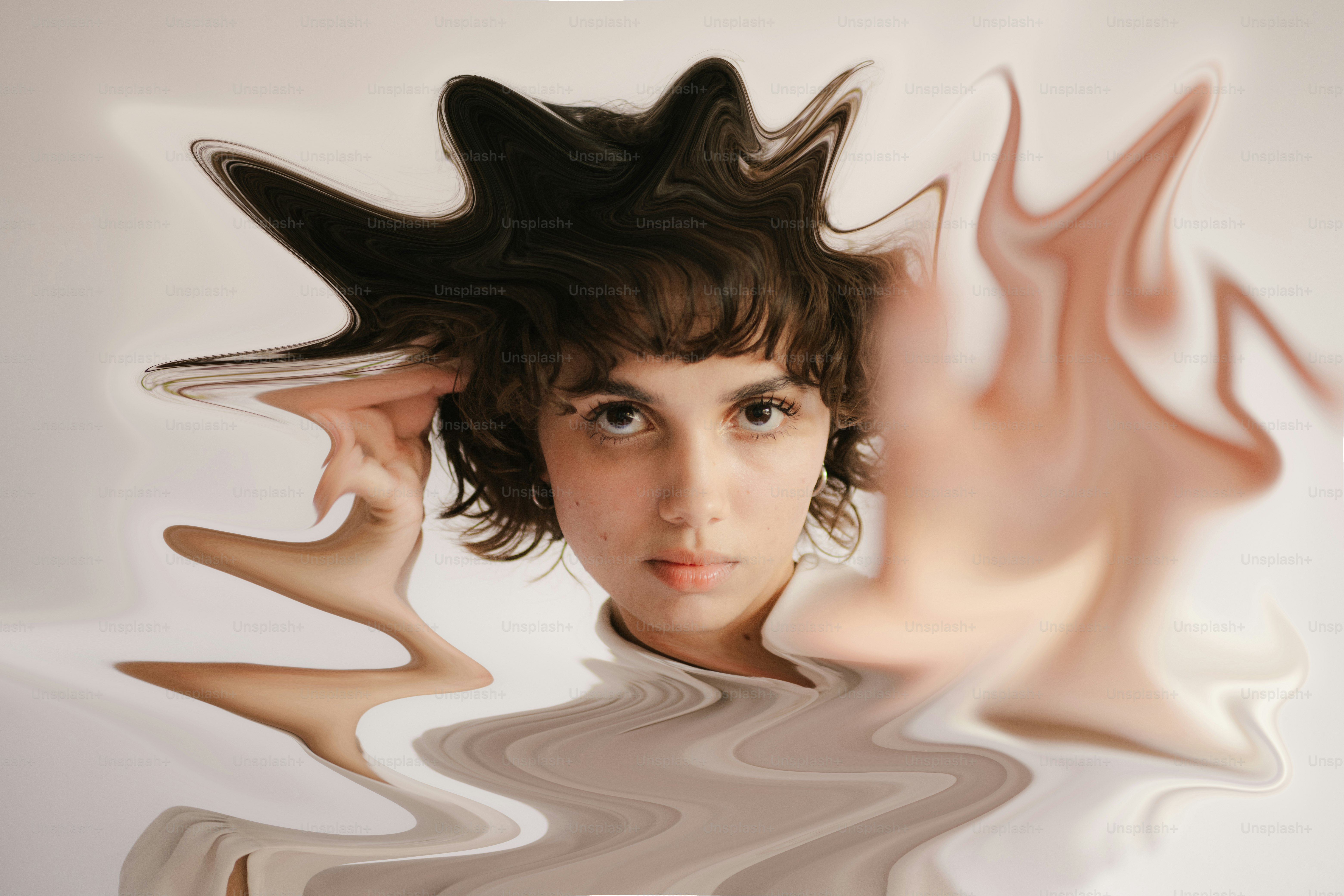 Woman with distorted reflection against a plain background photo ...