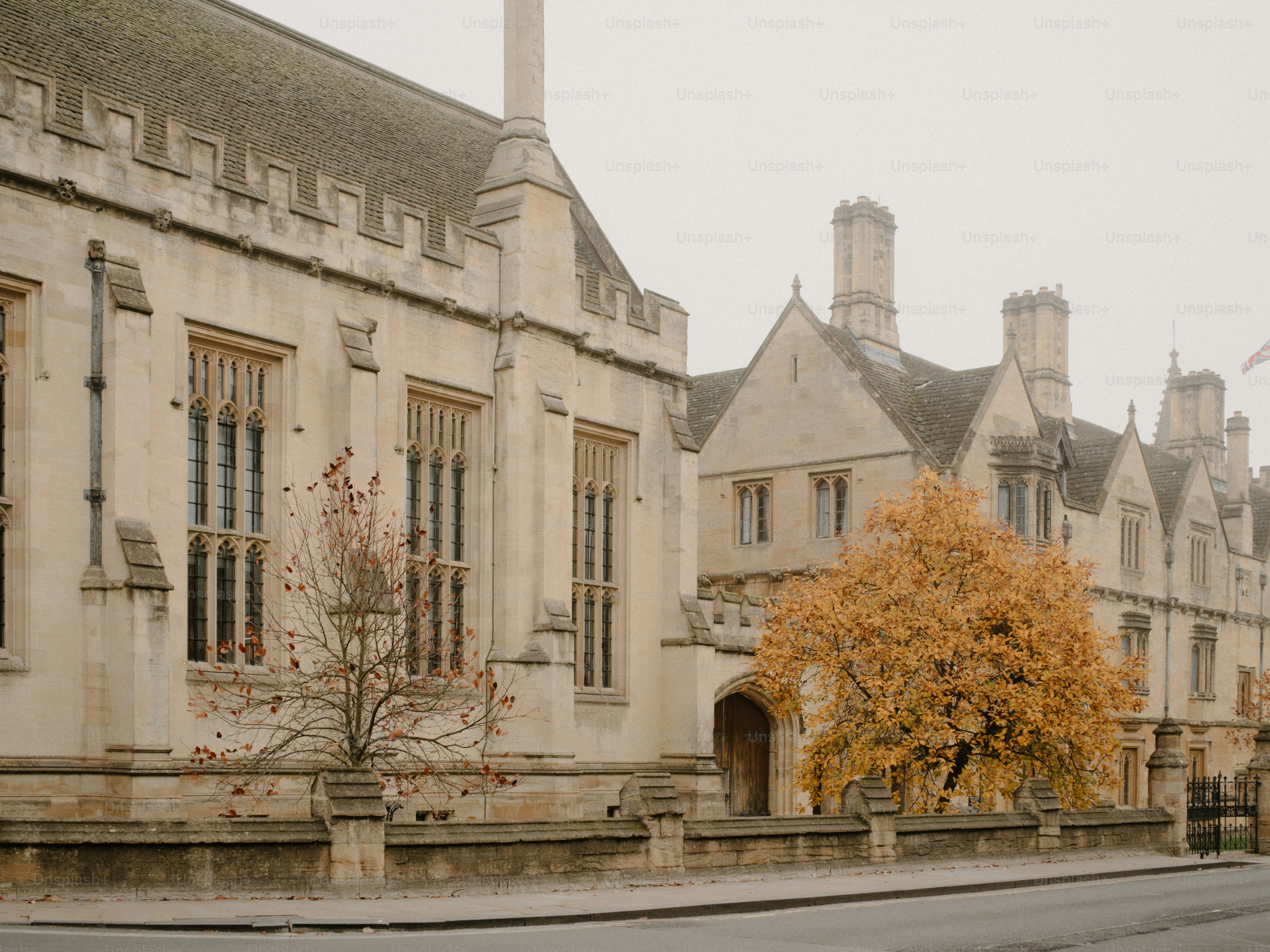 Ancien bâtiment en pierre avec un arbre d’automne devant