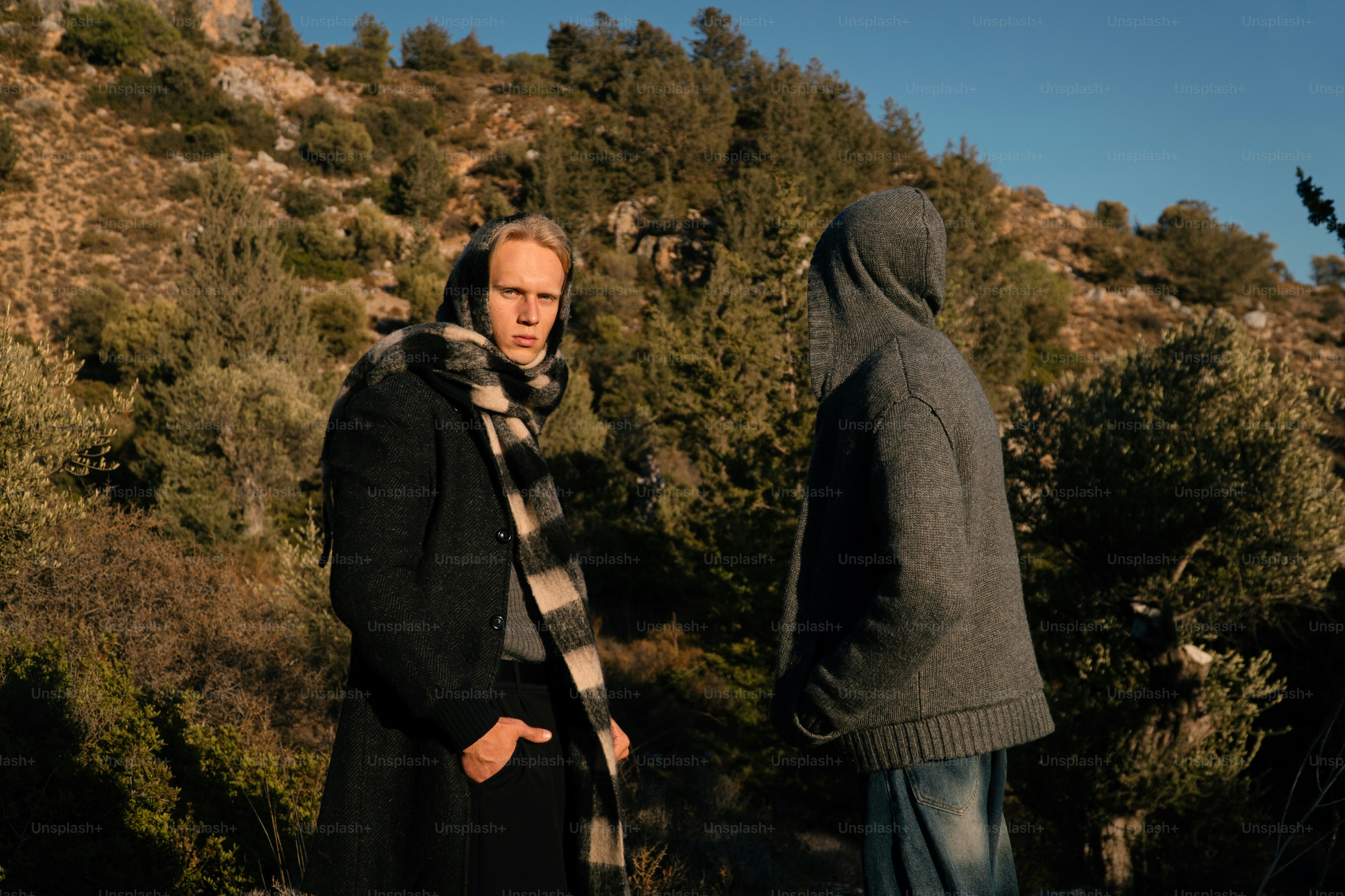 Two men talking outdoors on a sunny day.