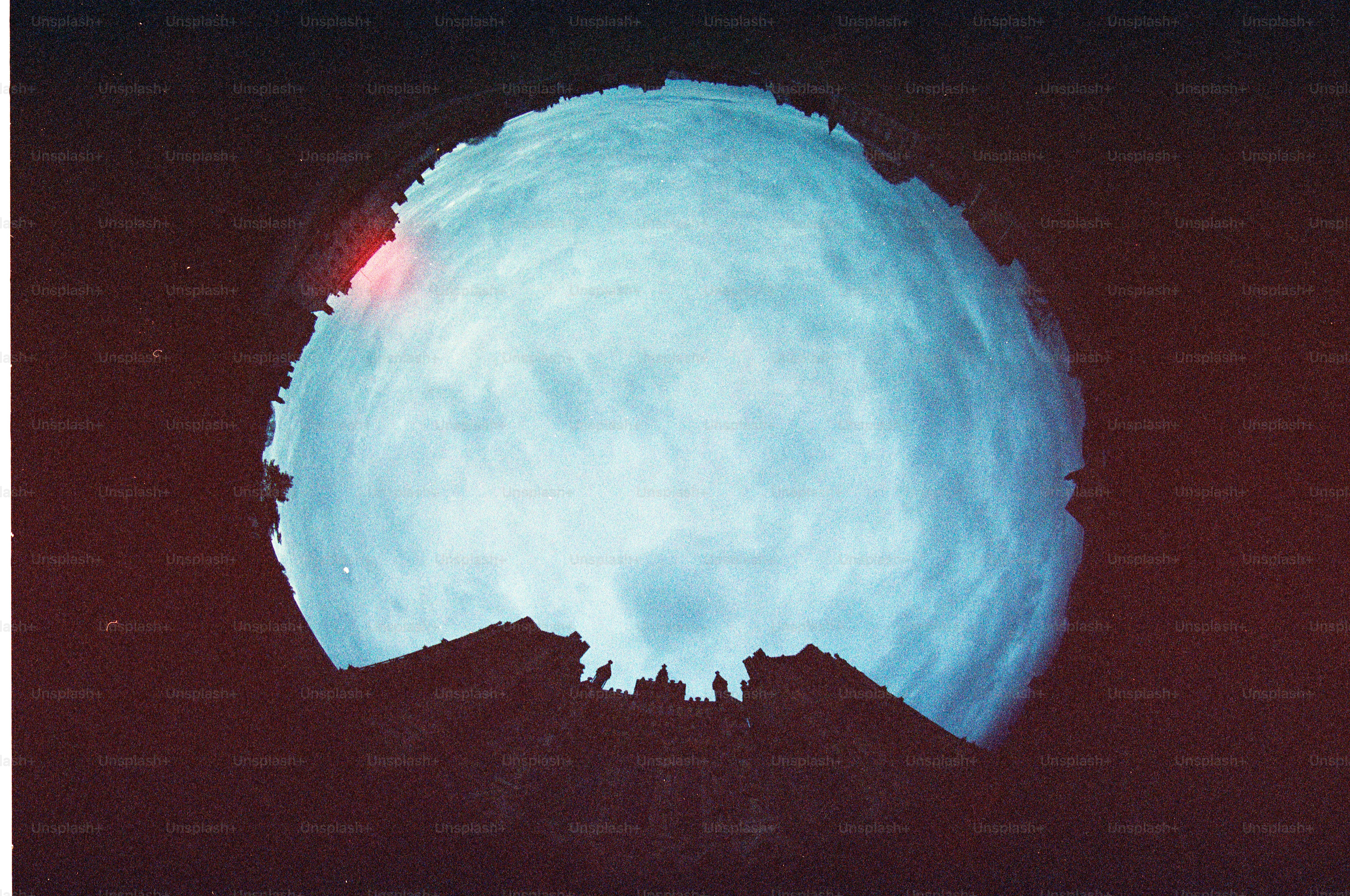 A bright blue star with a red flare