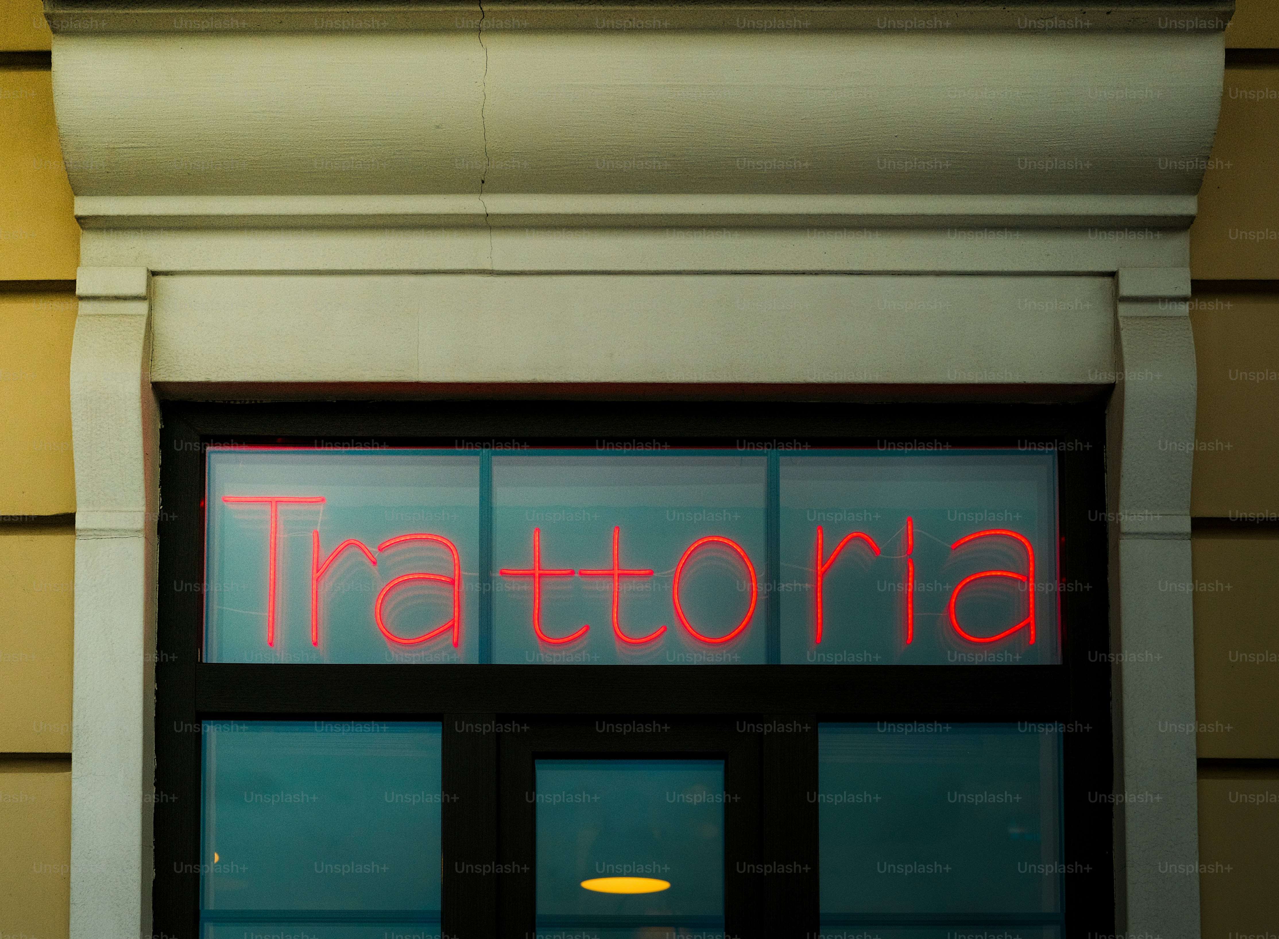 Trattoria sign glowing in neon lights