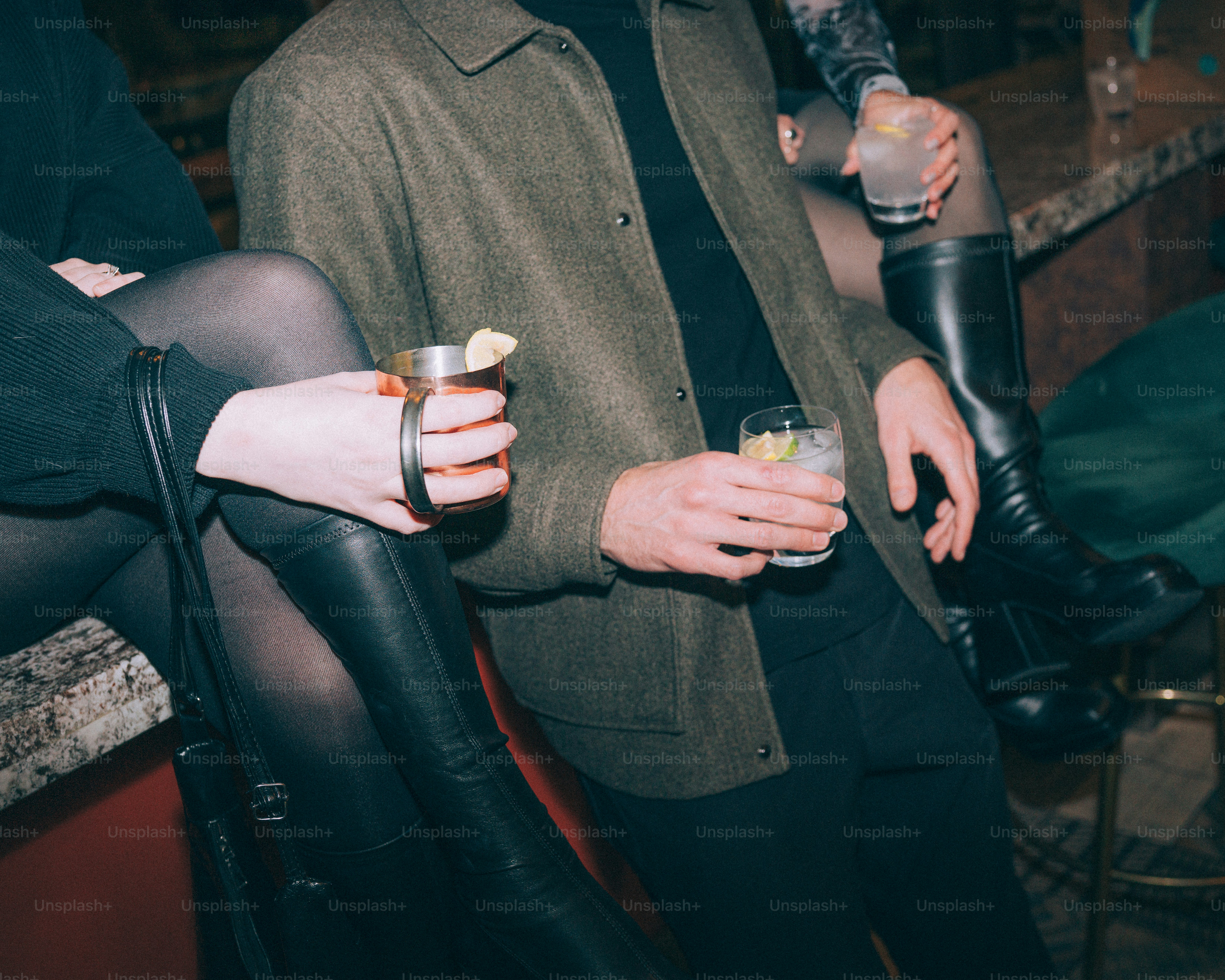 People sitting at a bar with drinks