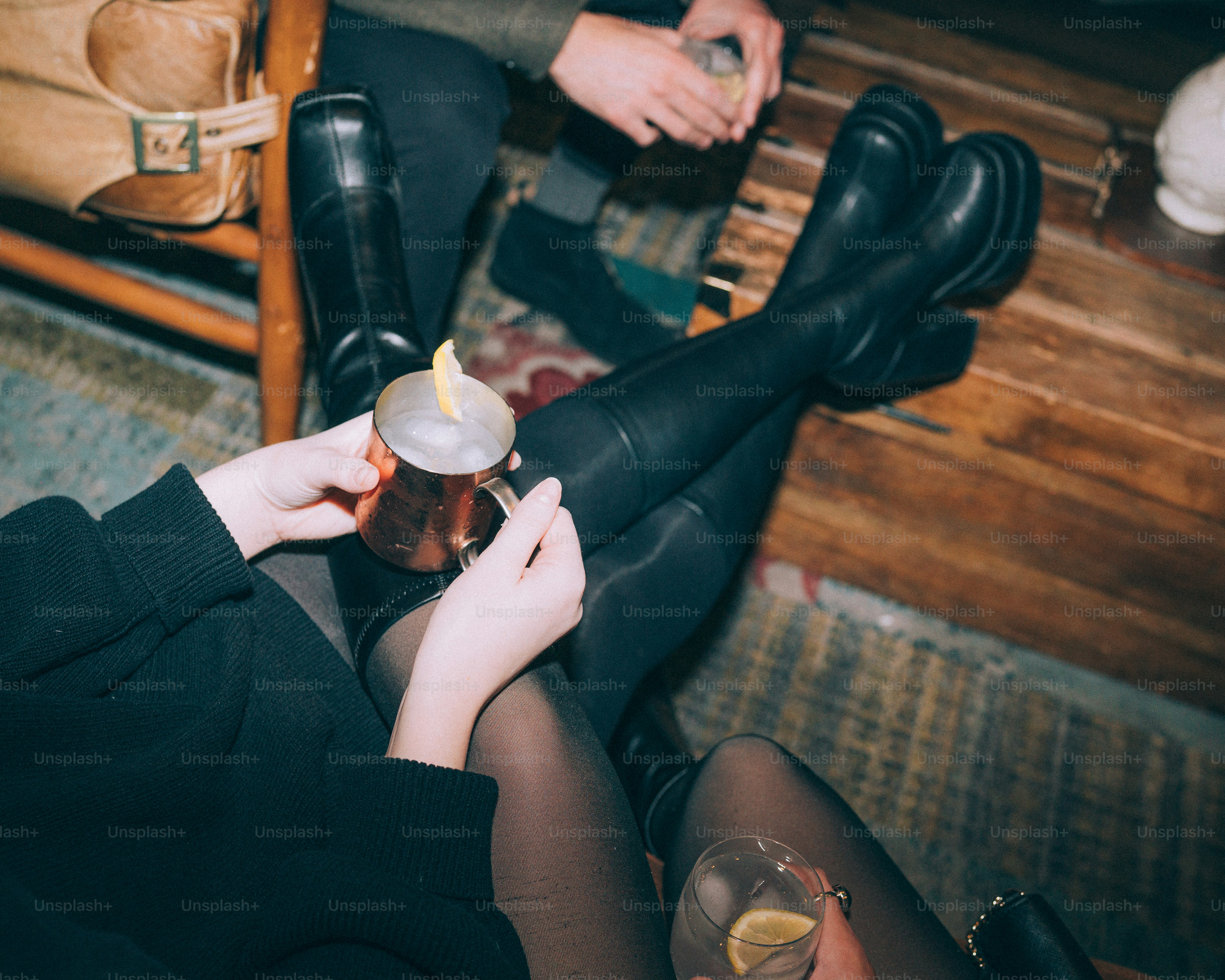 People with drinks sitting in a dimly lit room. photo – Nightlife Image on  Unsplash, image size:3000x2400