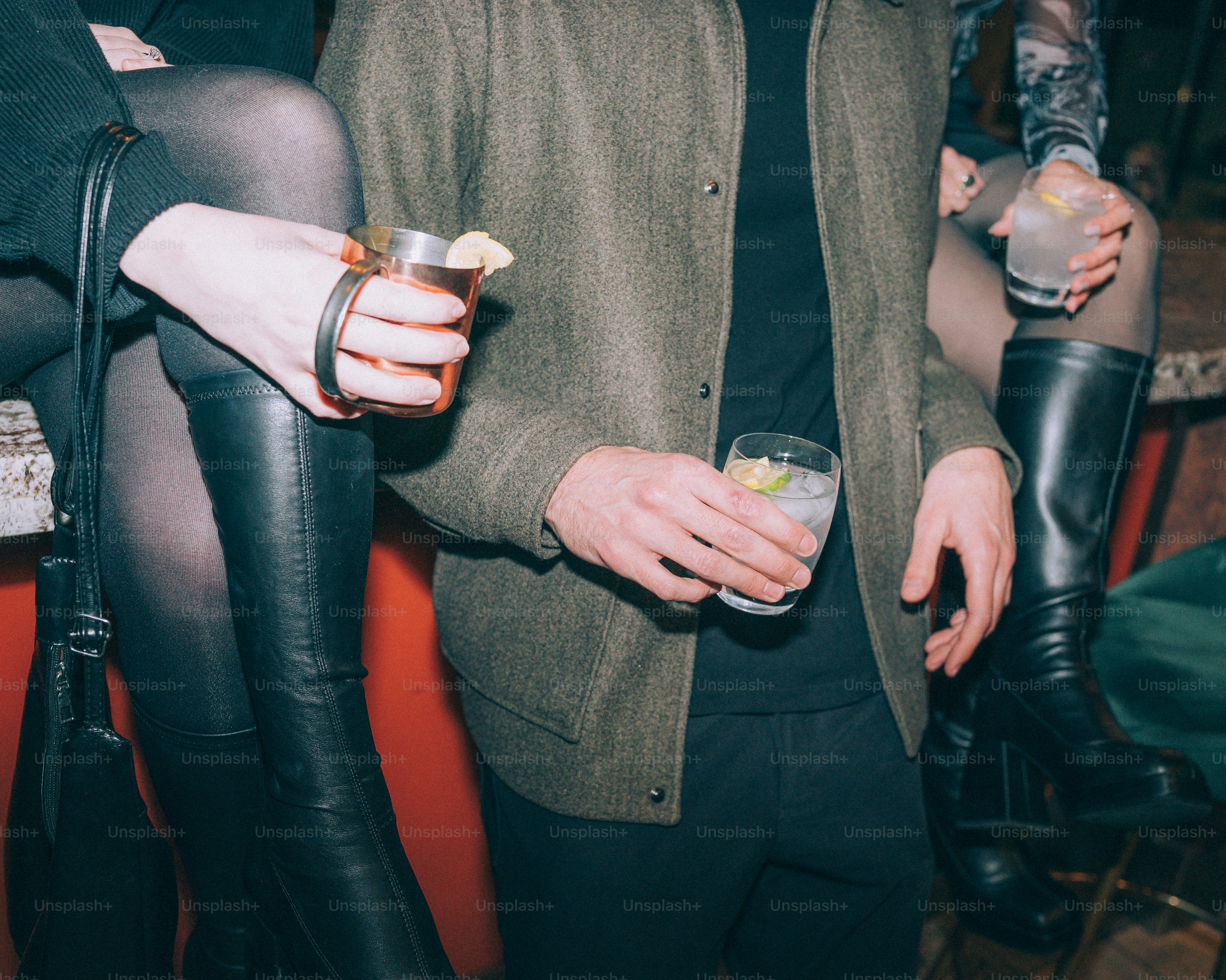 People holding drinks at a bar