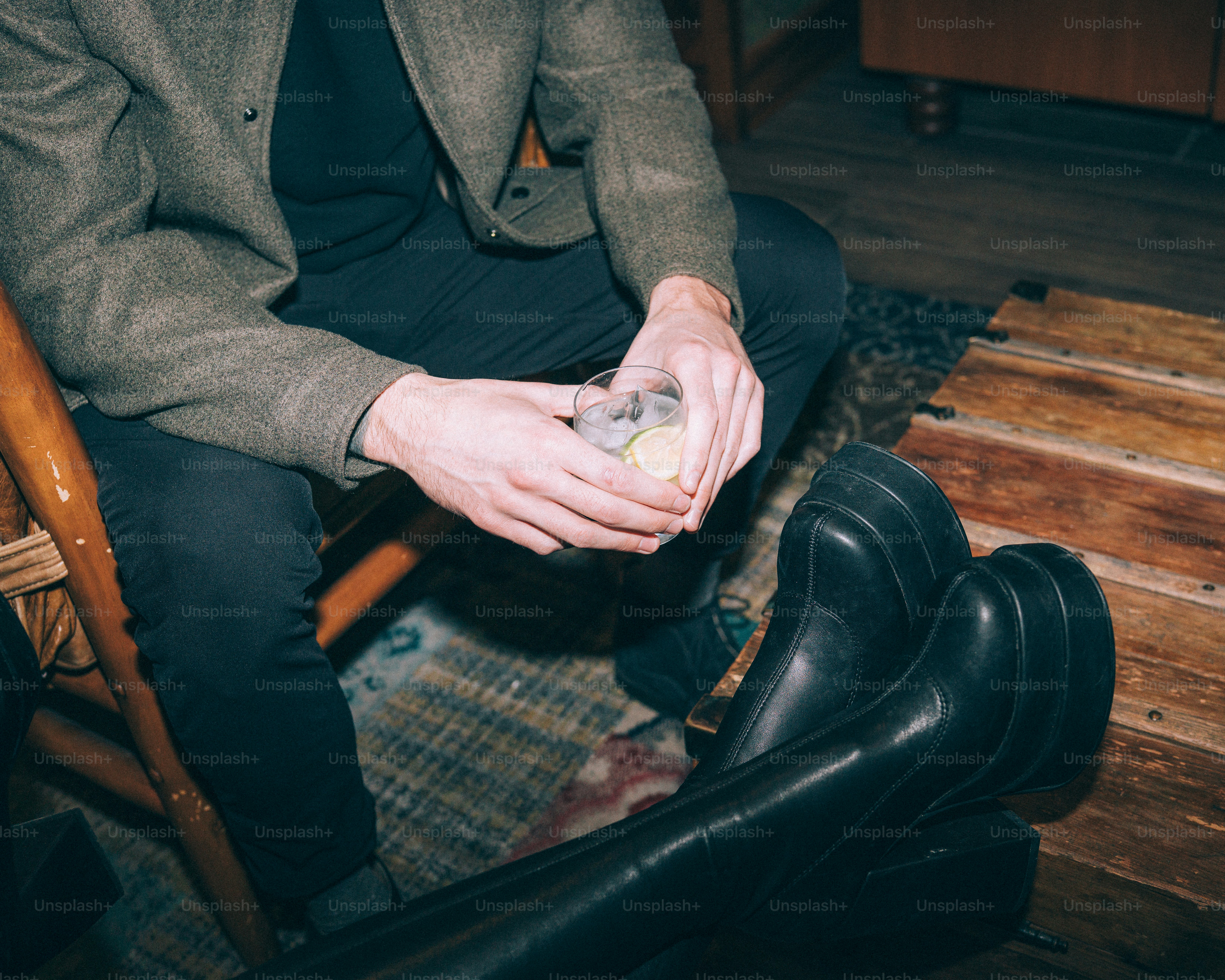 Two people sitting with drinks and boots