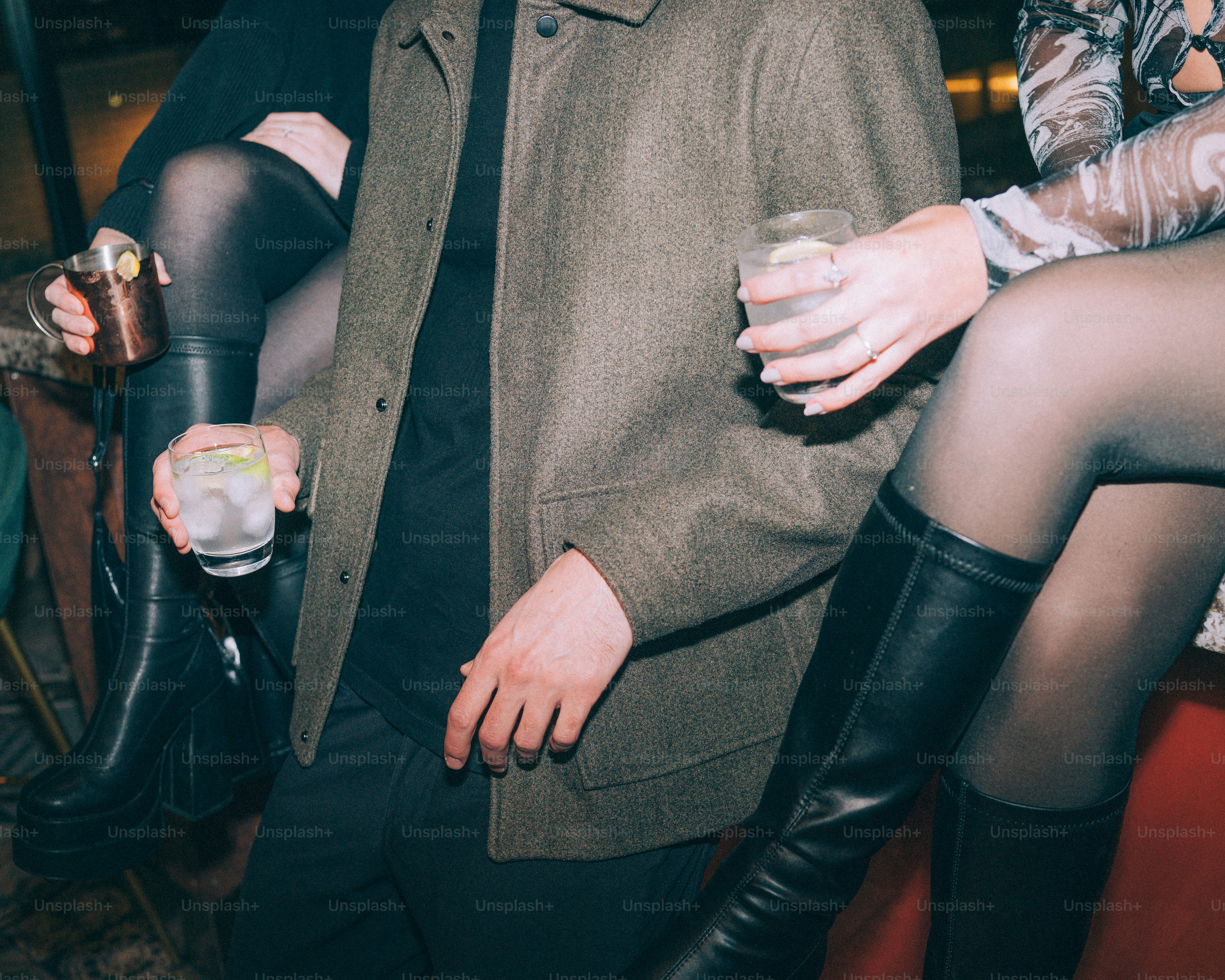 People holding drinks at a social gathering.