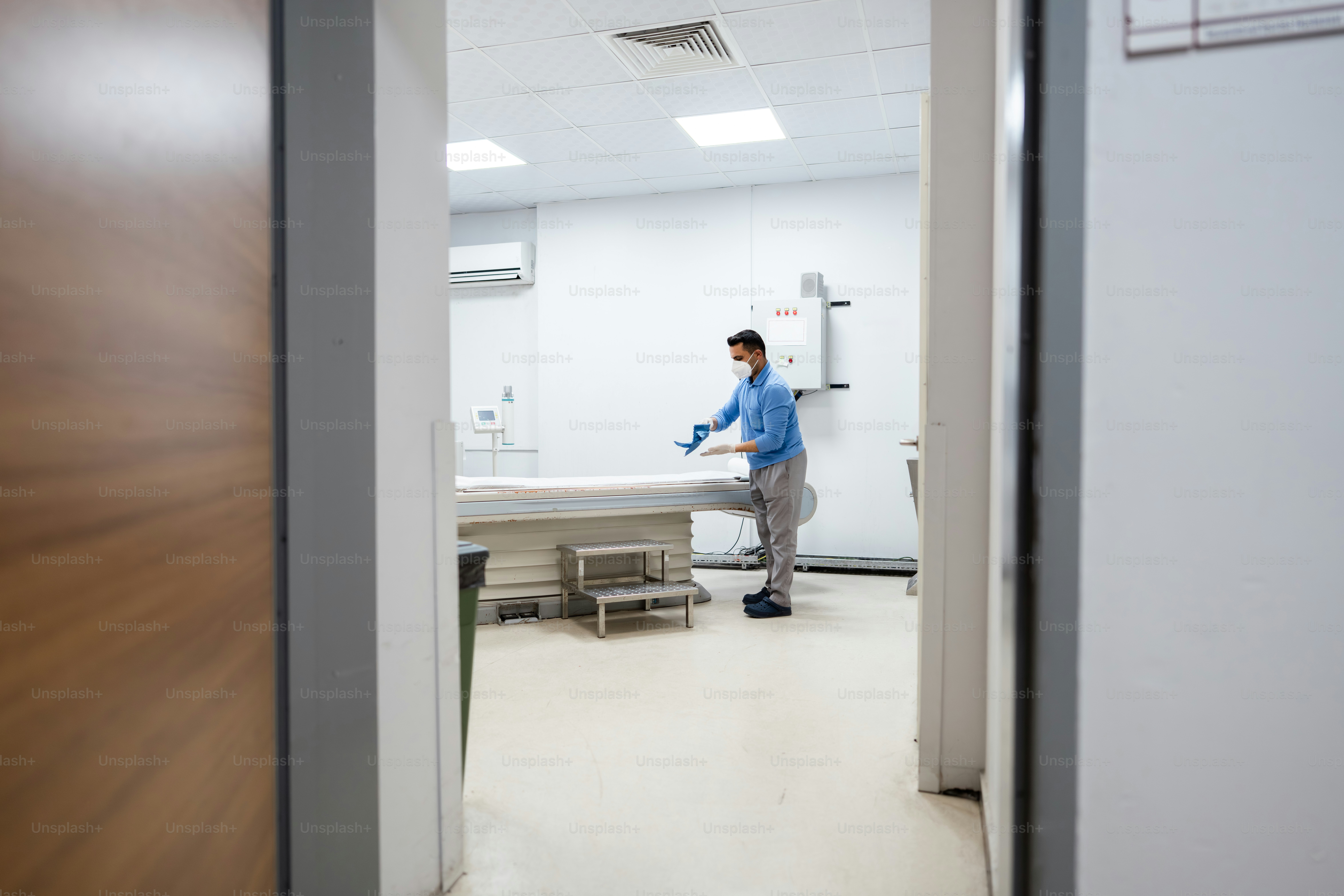 Man in medical room cleaning equipment