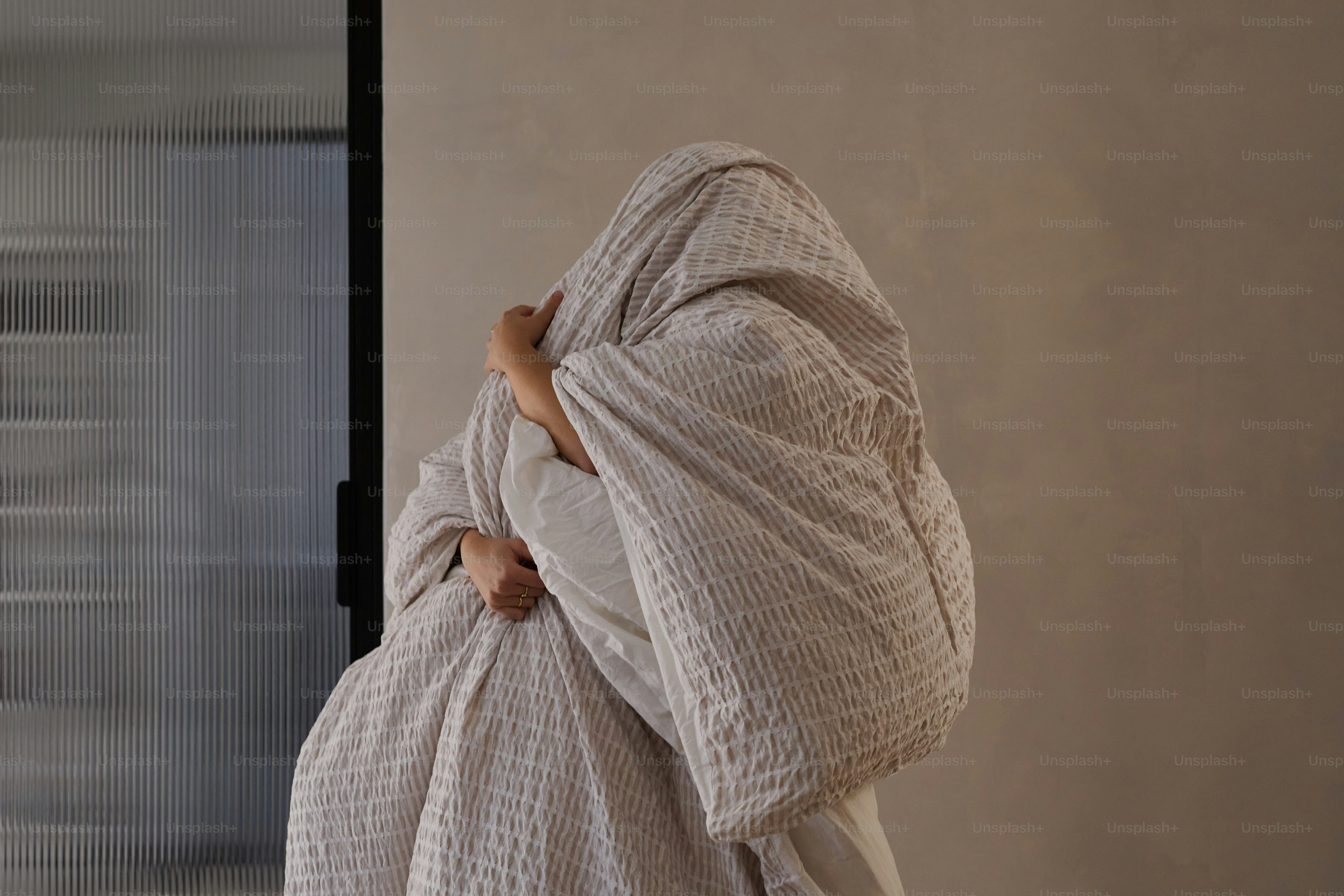Person wrapped tightly in a textured blanket. photo – Self care Image ...