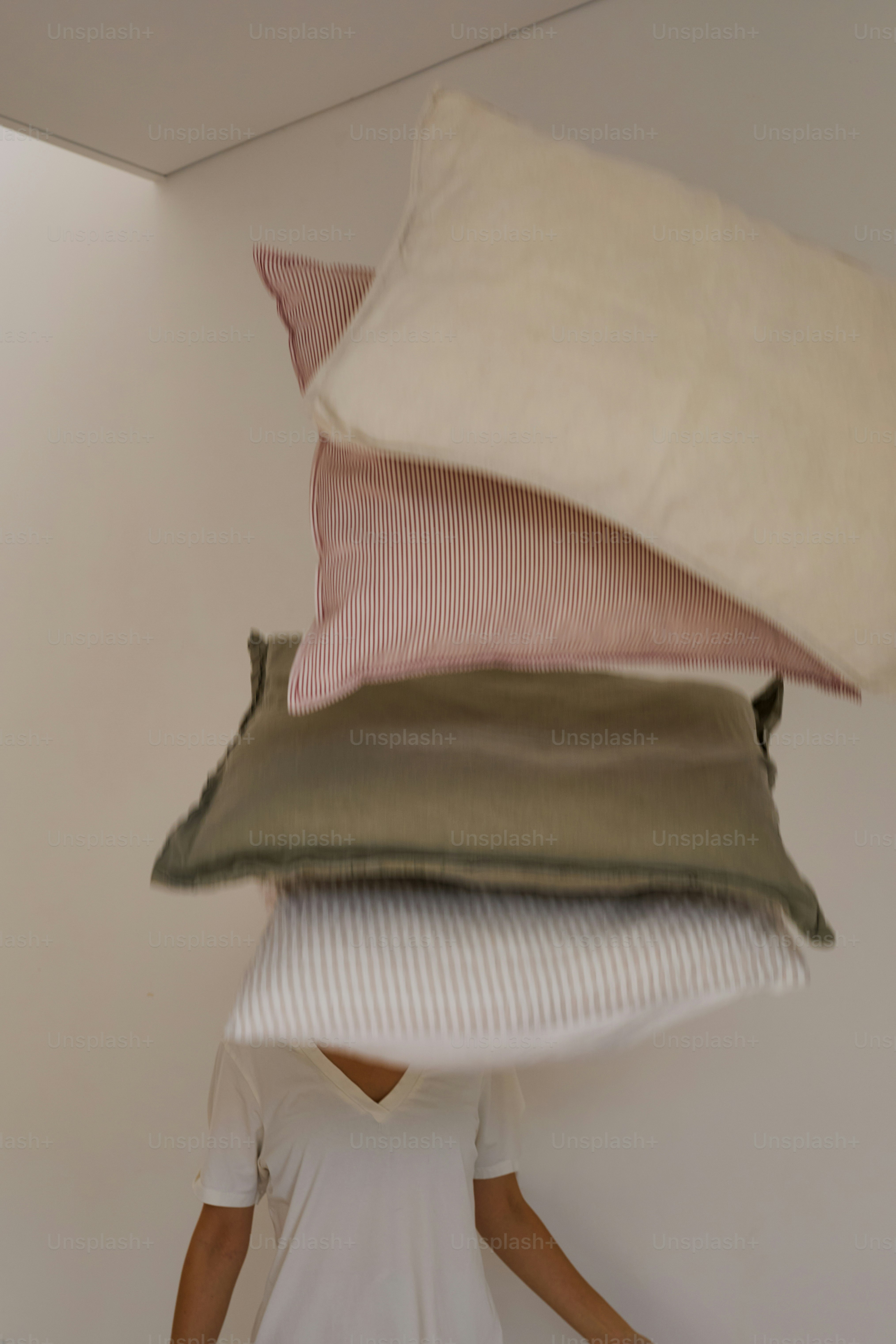 Person hiding under a striped blanket on a bed. photo – Cosy Image on ...