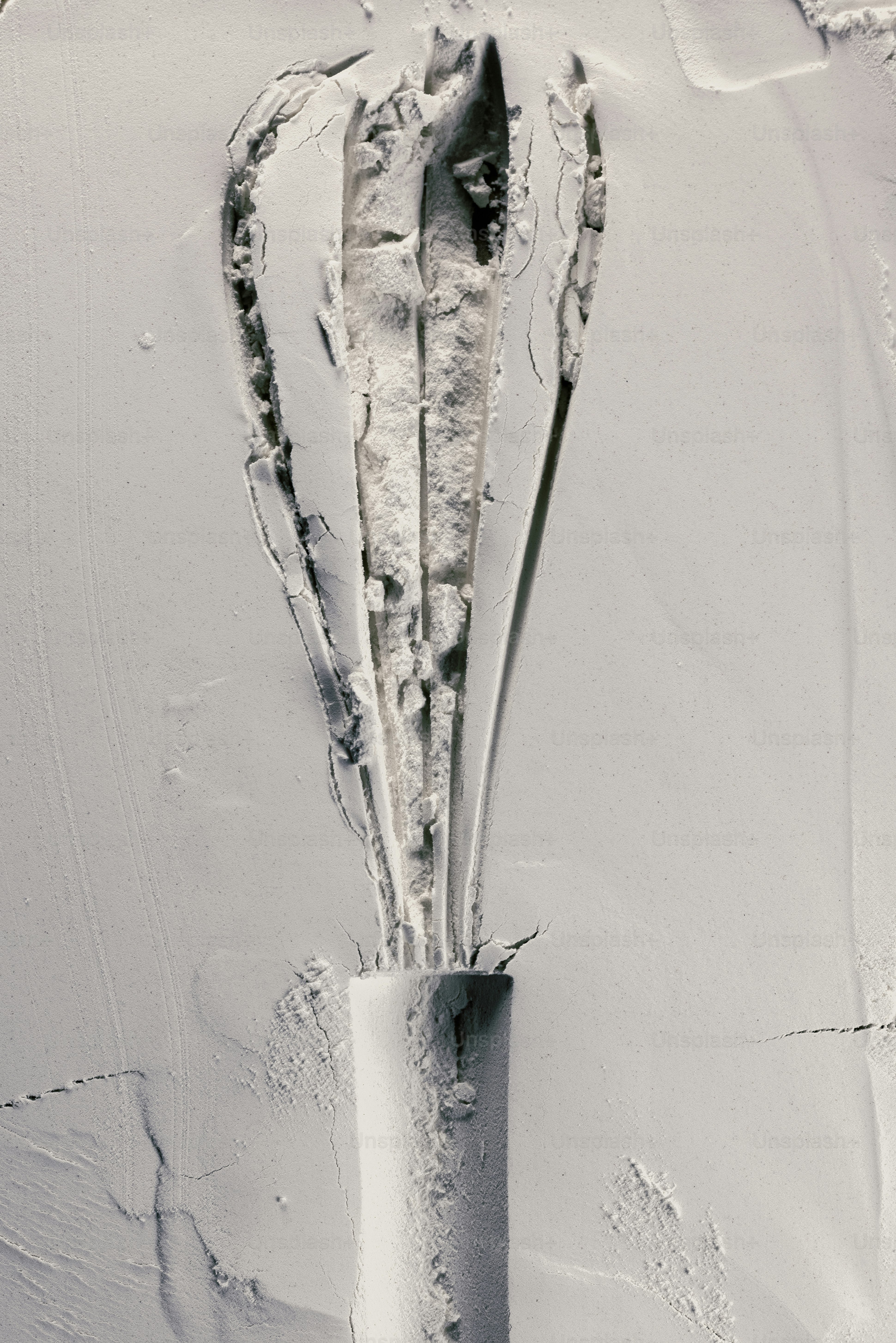 Close-up of a textured white surface with a central crack.