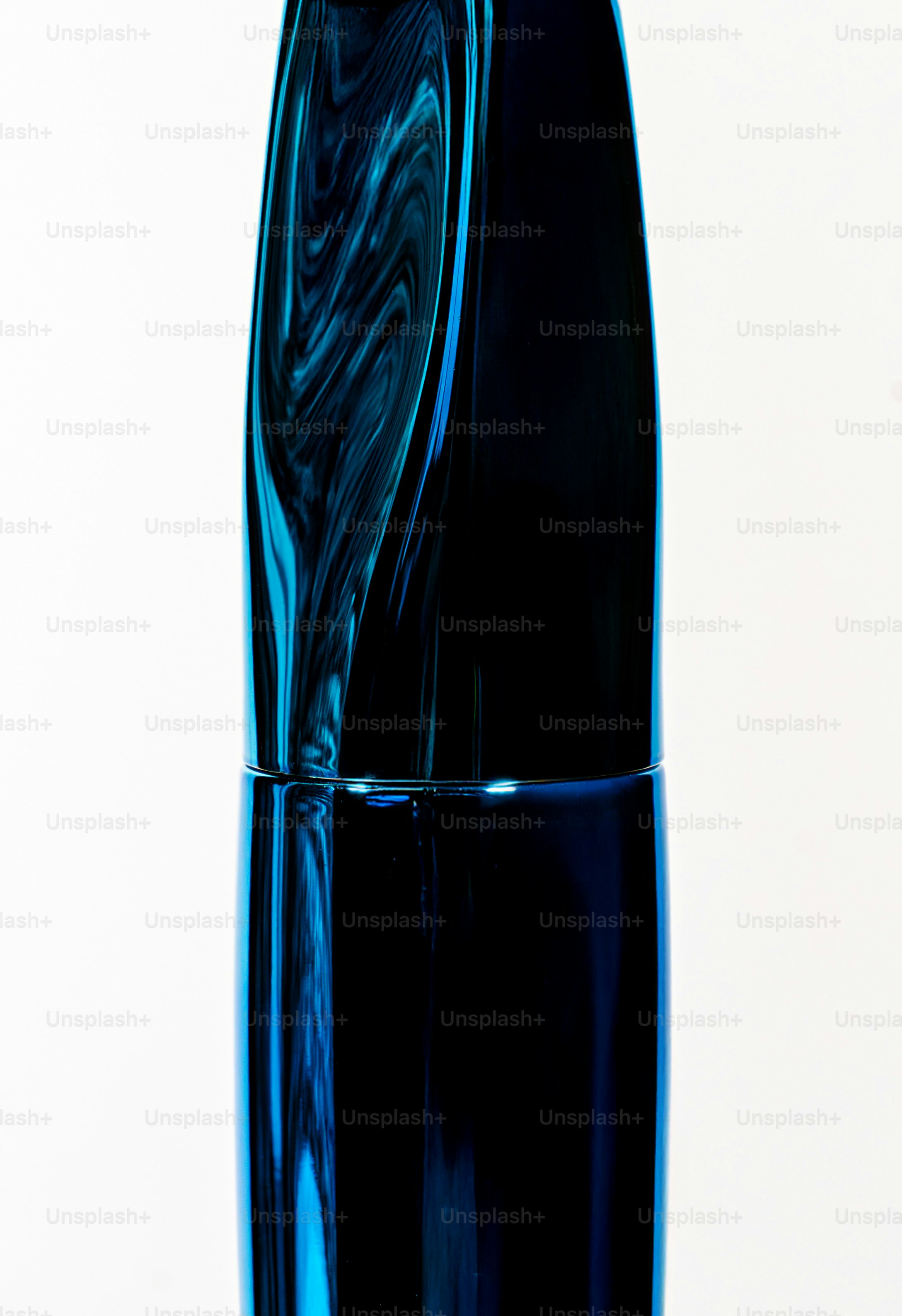 Close-up of a dark blue glass bottle with swirling patterns