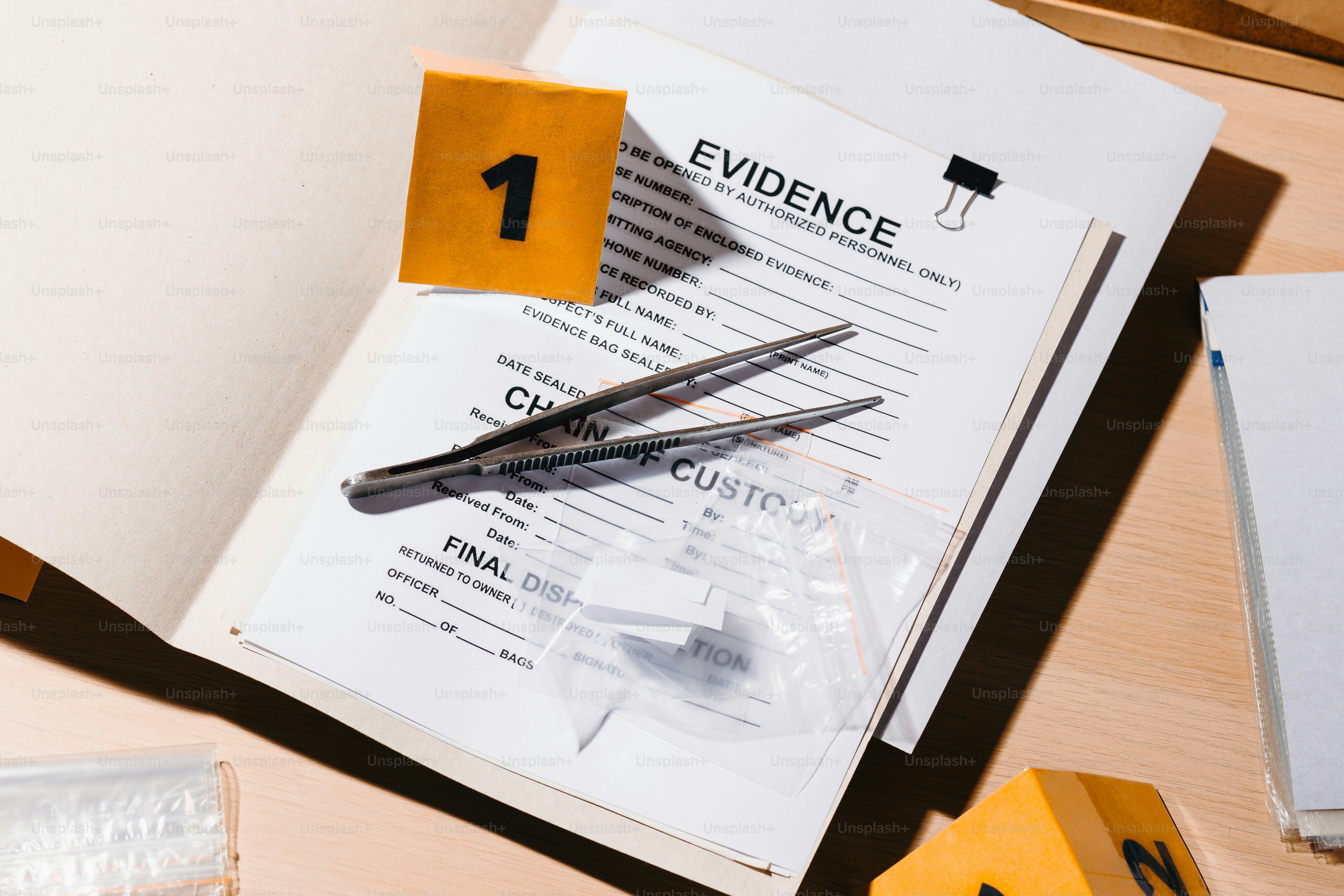 Crime scene evidence with tweezers and baggie bag