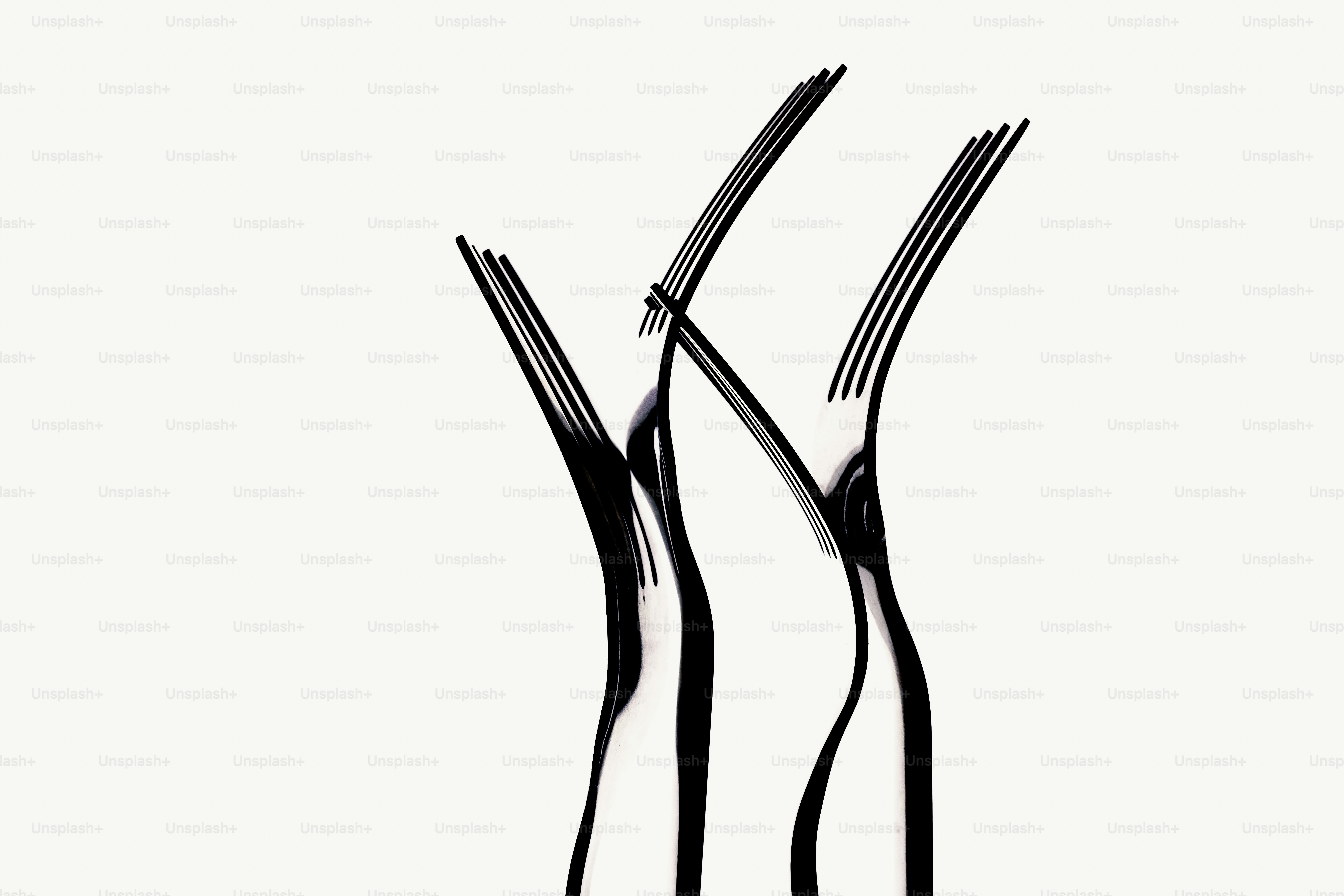 Three black forks arranged in a stylized cluster.