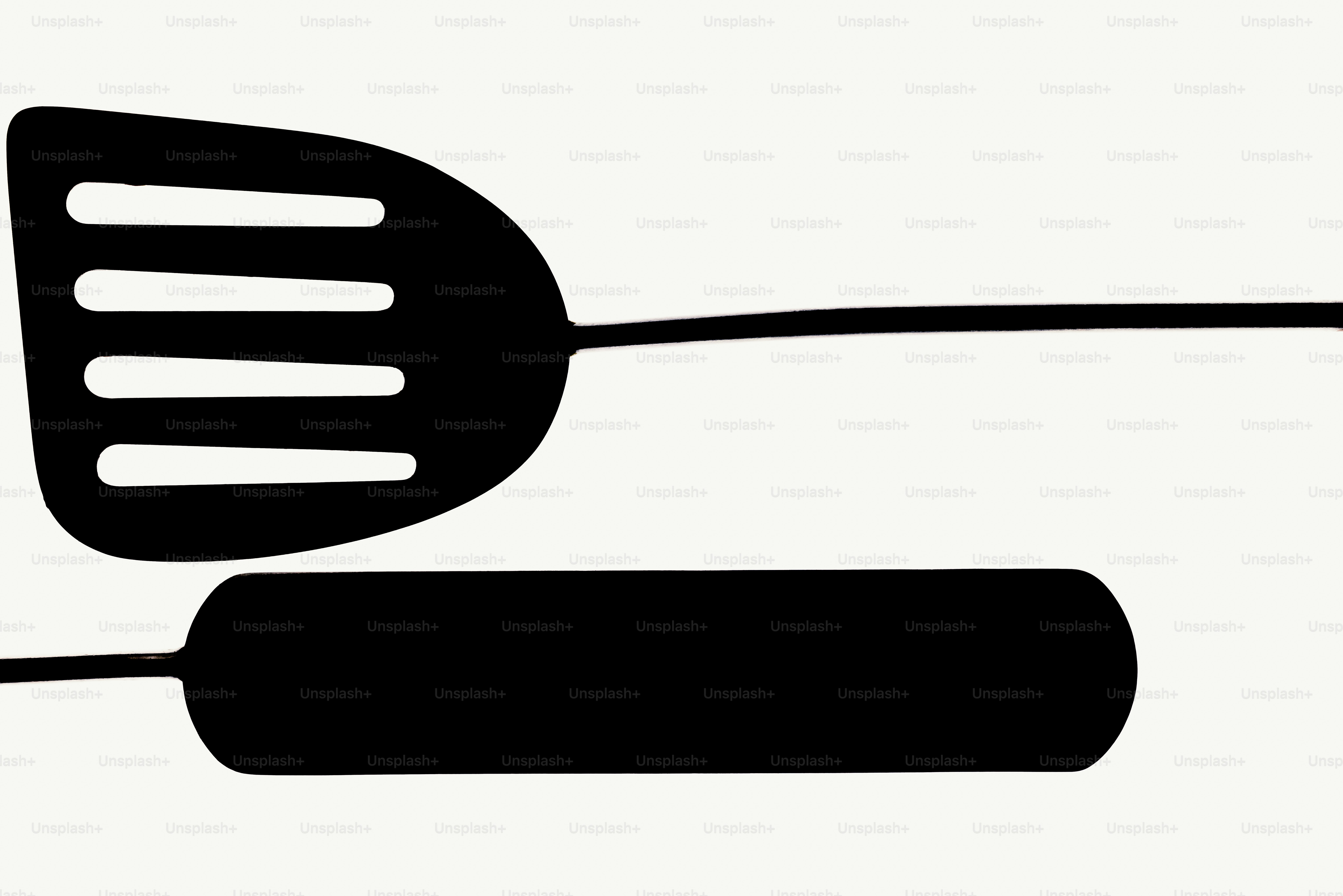 Black spatula and tongs on white background