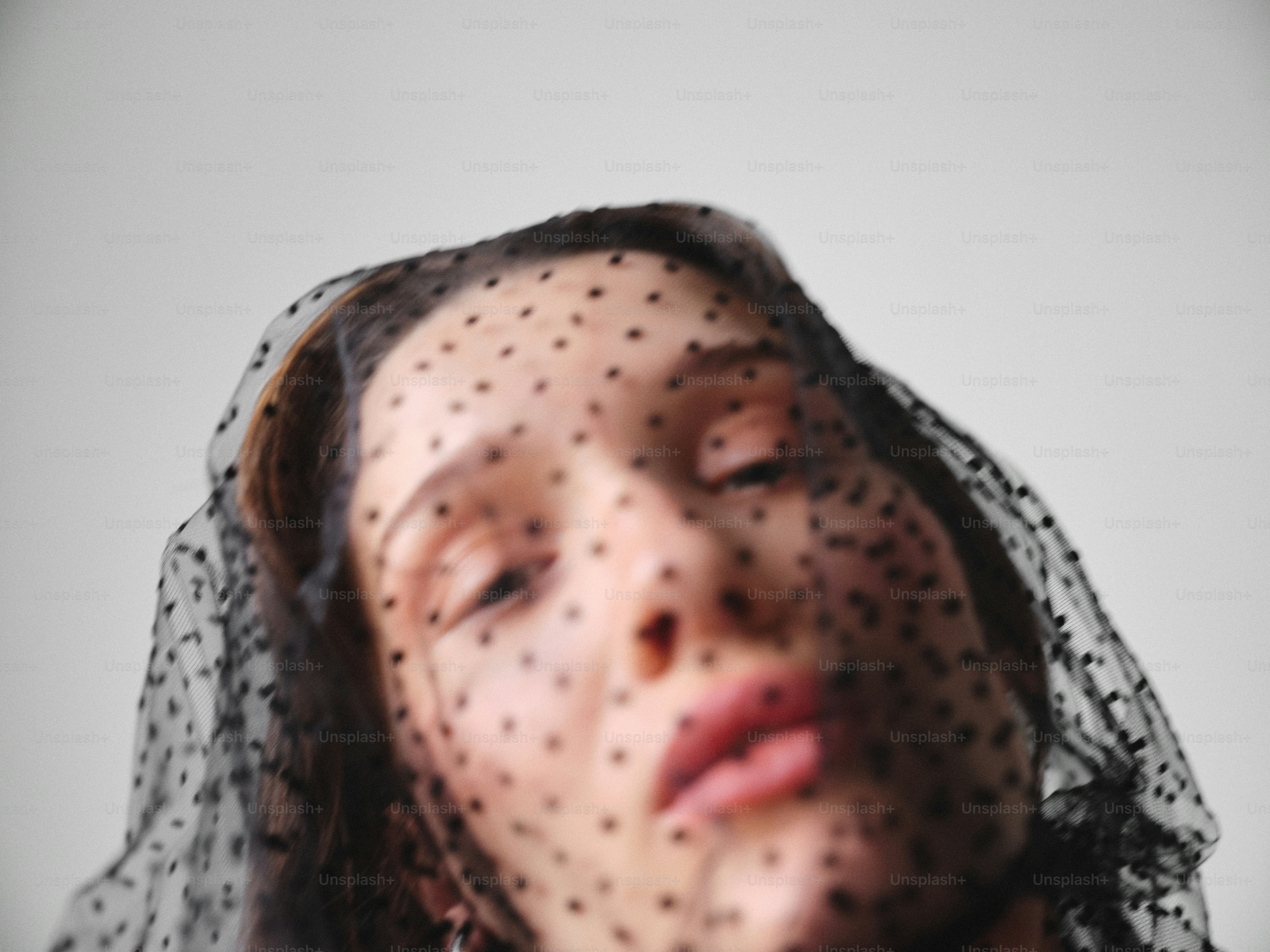 Woman wearing a black polka dot veil