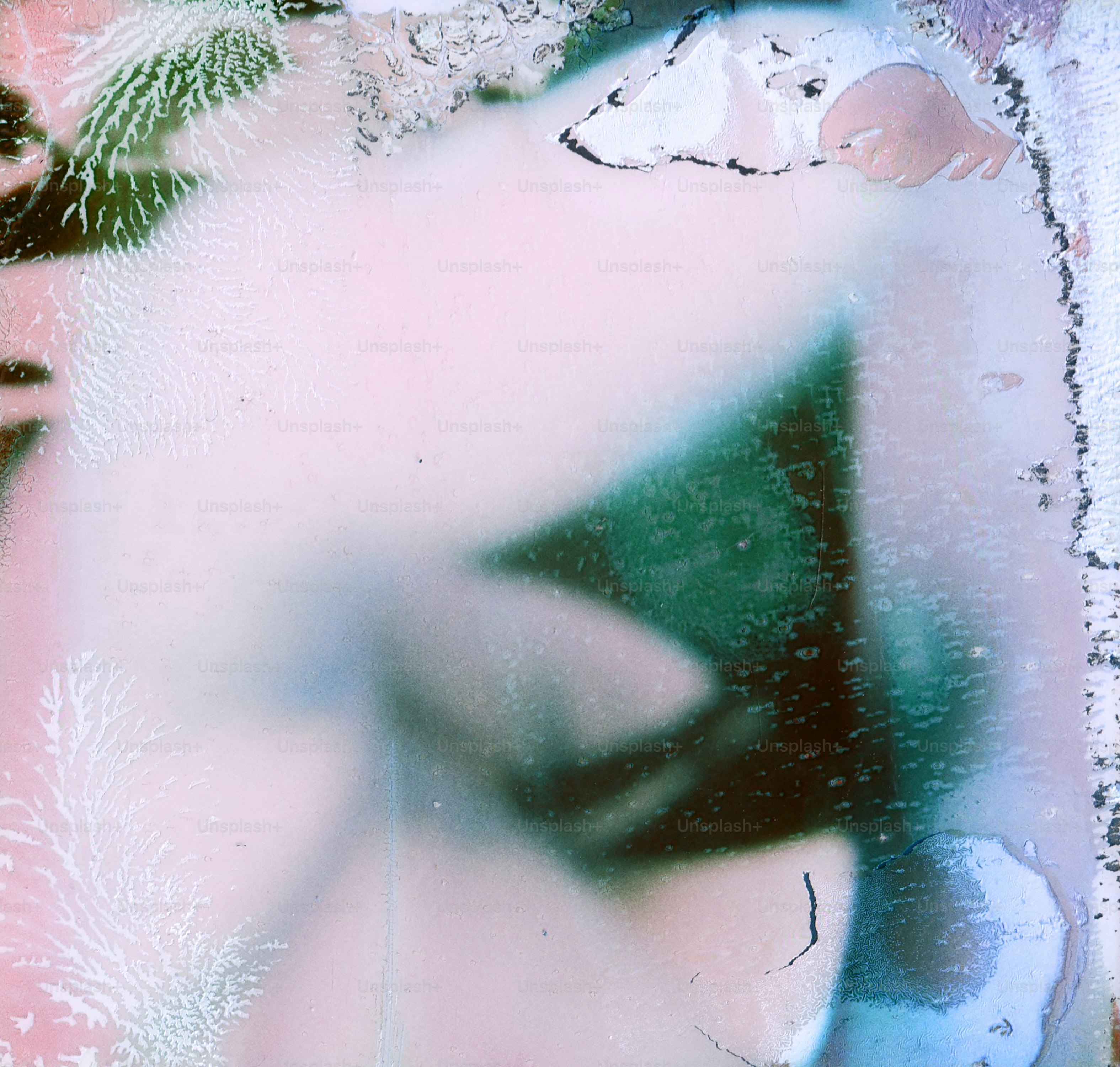 Abstract watercolor splashes with pink and blue hues.