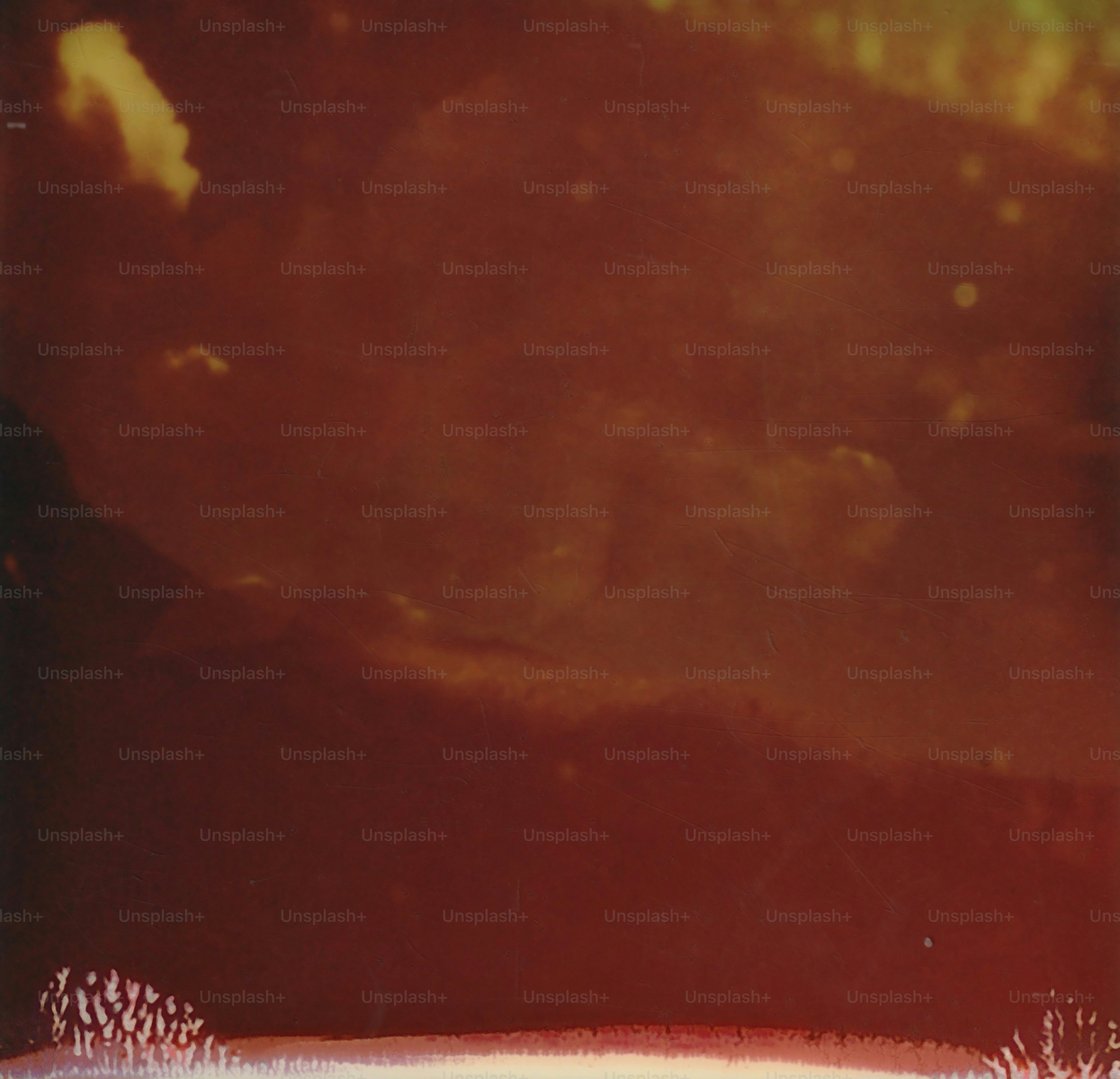 Abstract textured background with warm tones and light spots.