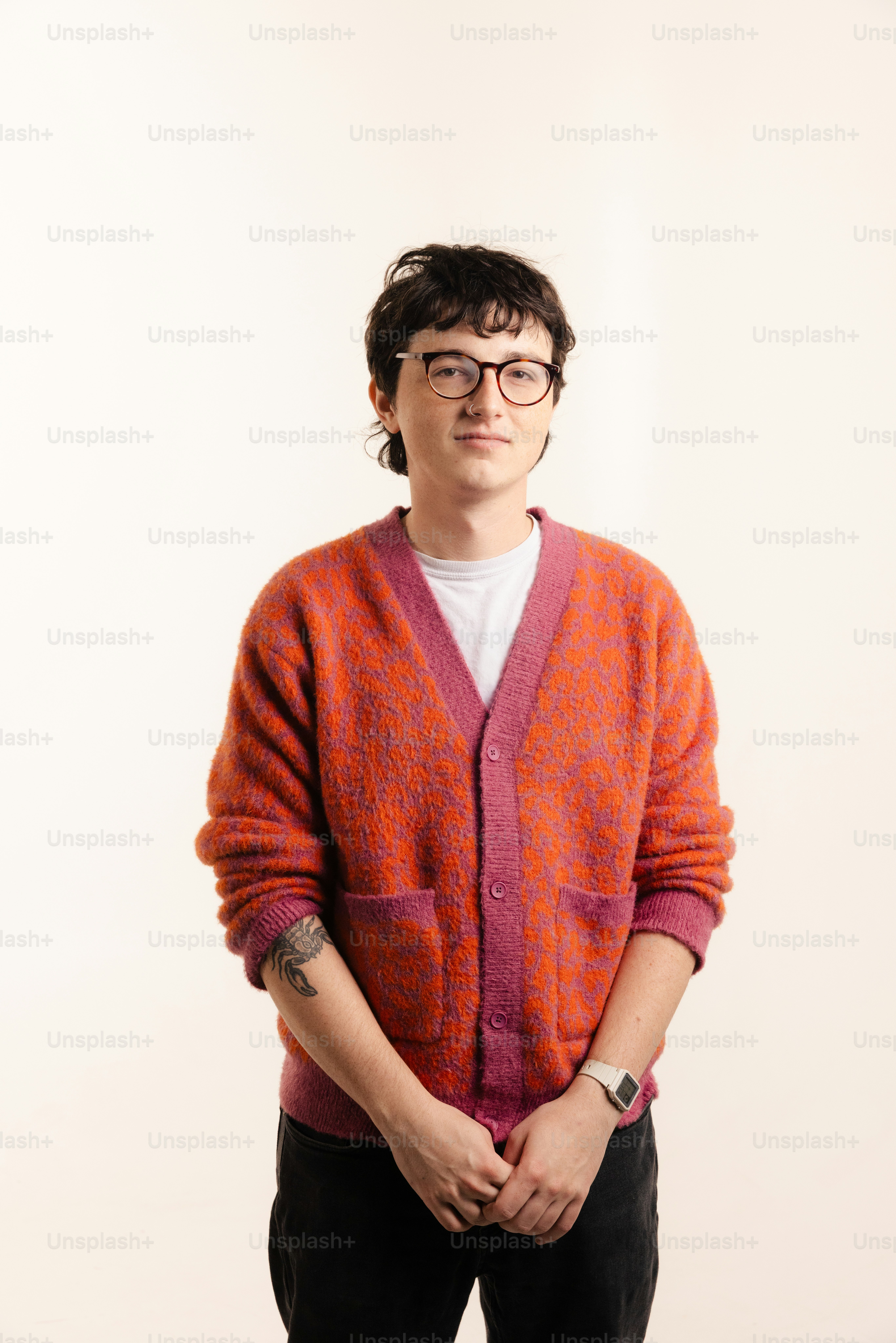 Jovem de óculos e cardigã laranja