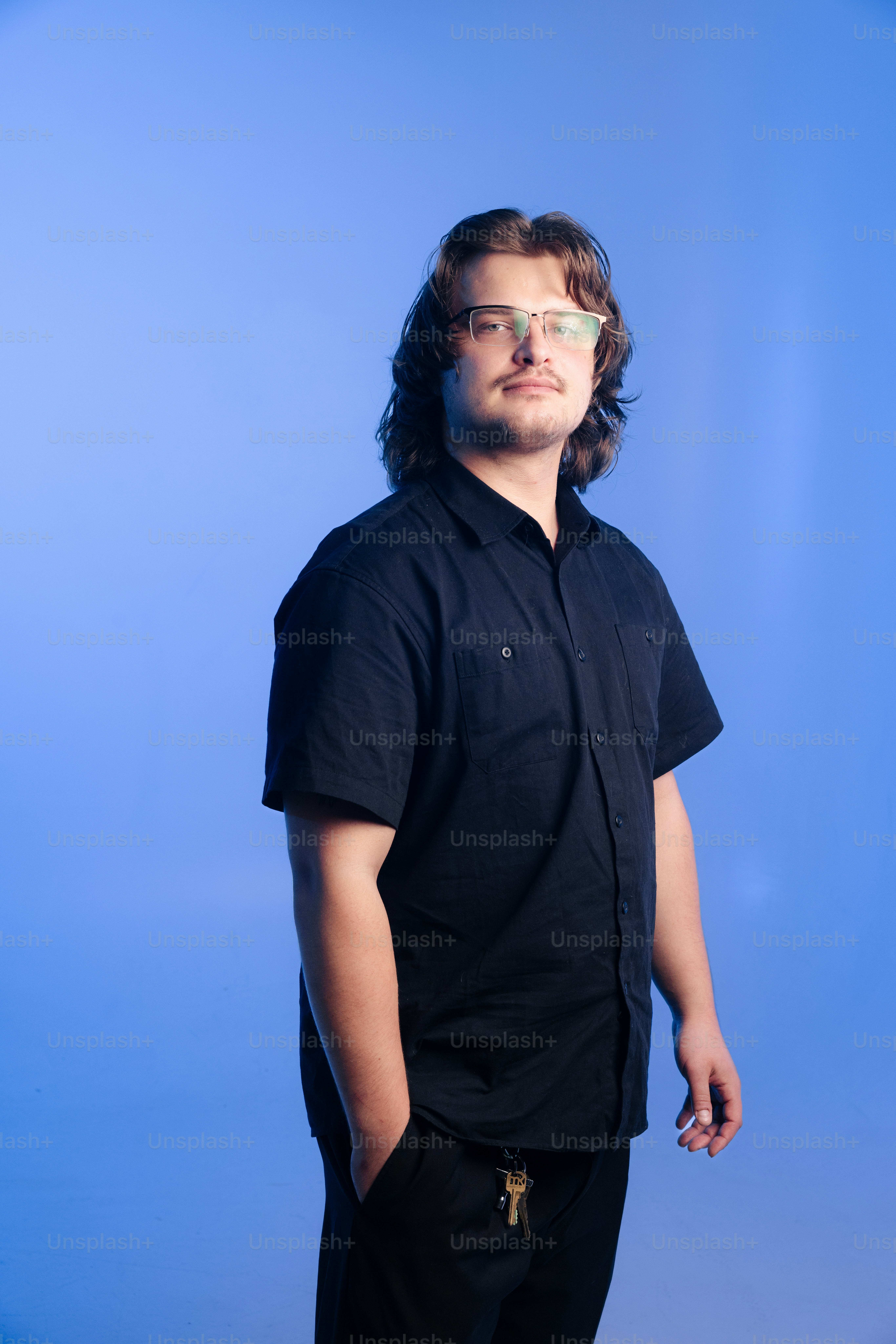 Jovem de óculos e camisa escura