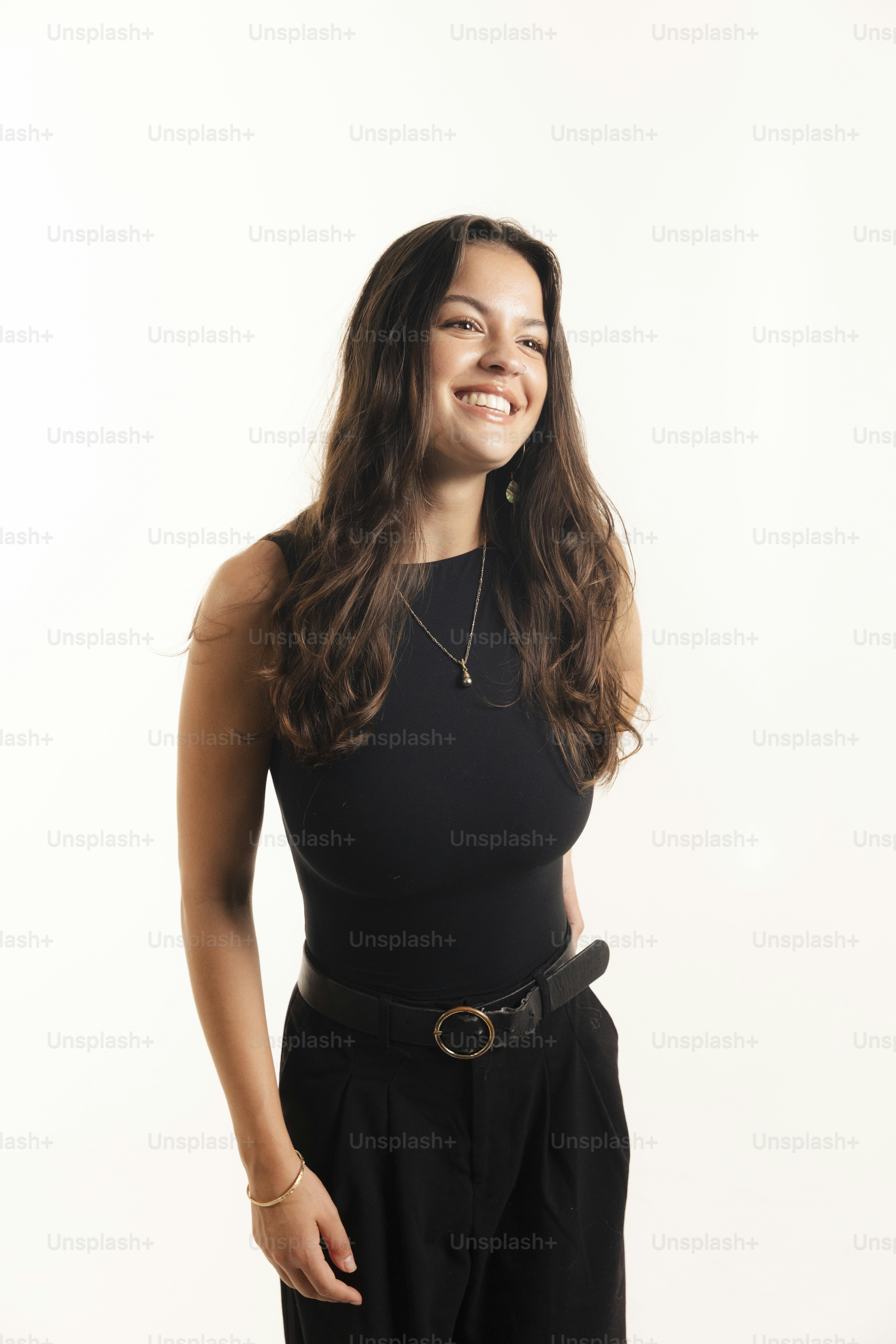 A smiling woman with long brown hair in black outfit photo – Portrait ...