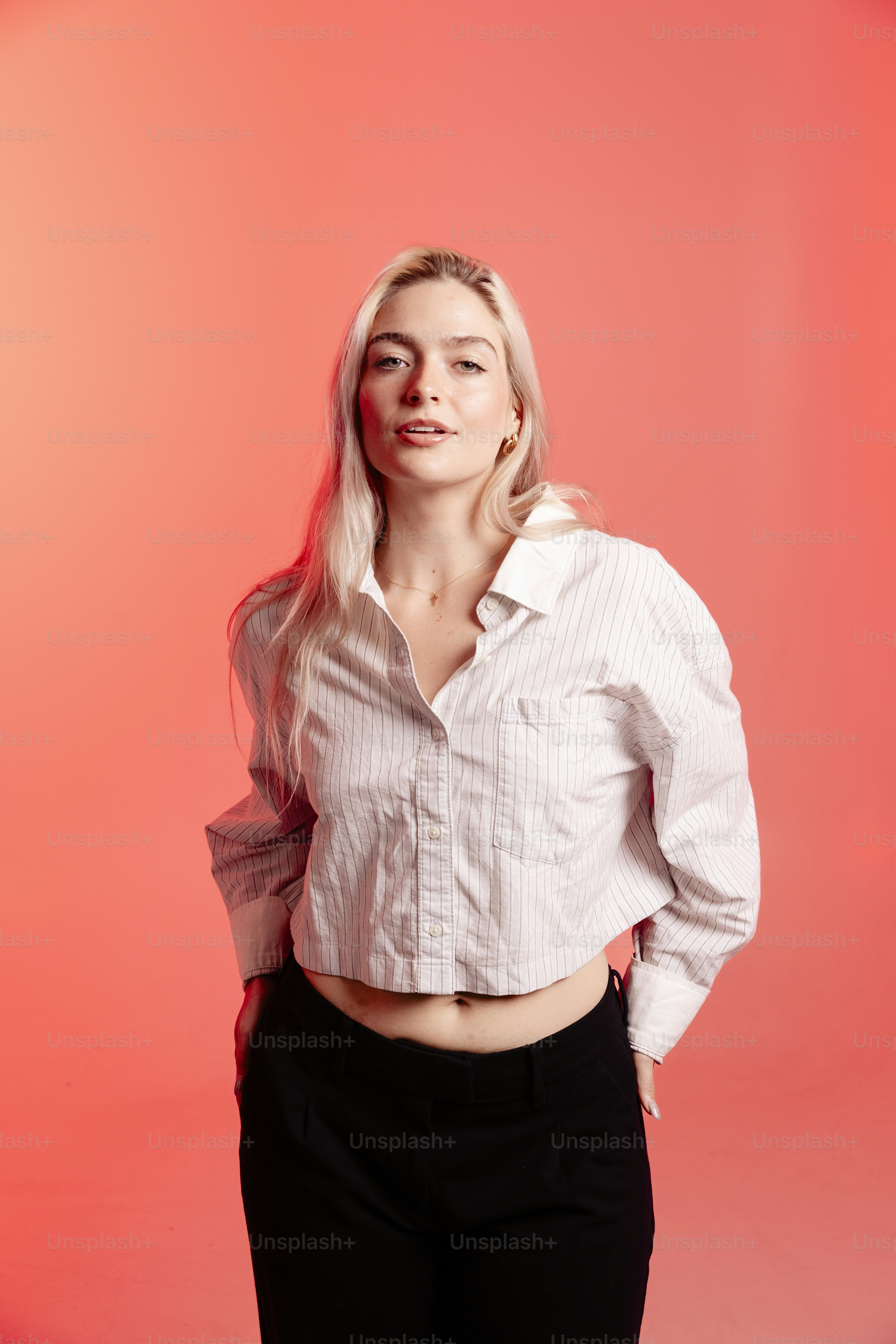 Uma jovem loira com uma camisa branca.