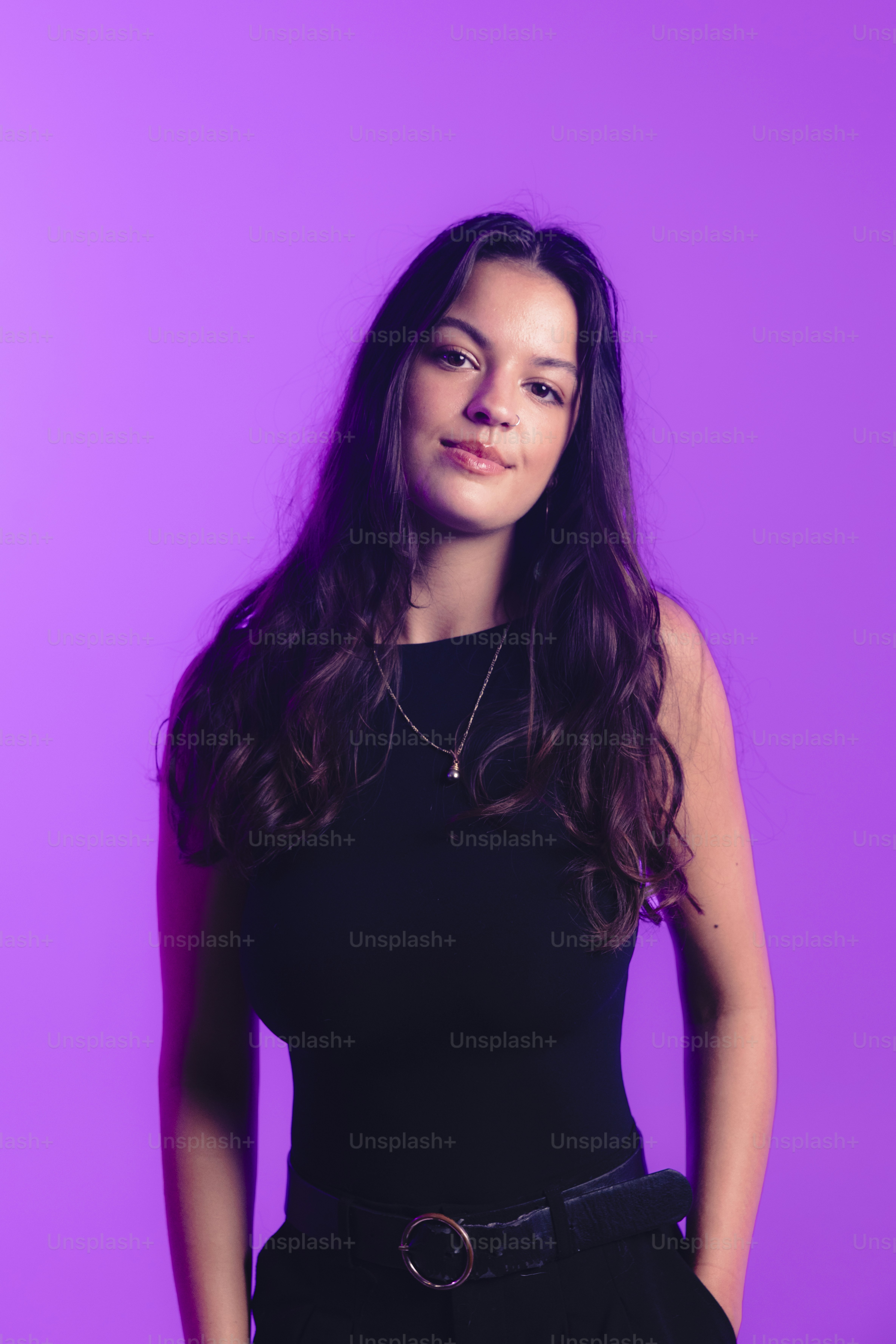 Young woman with long brown hair against purple background