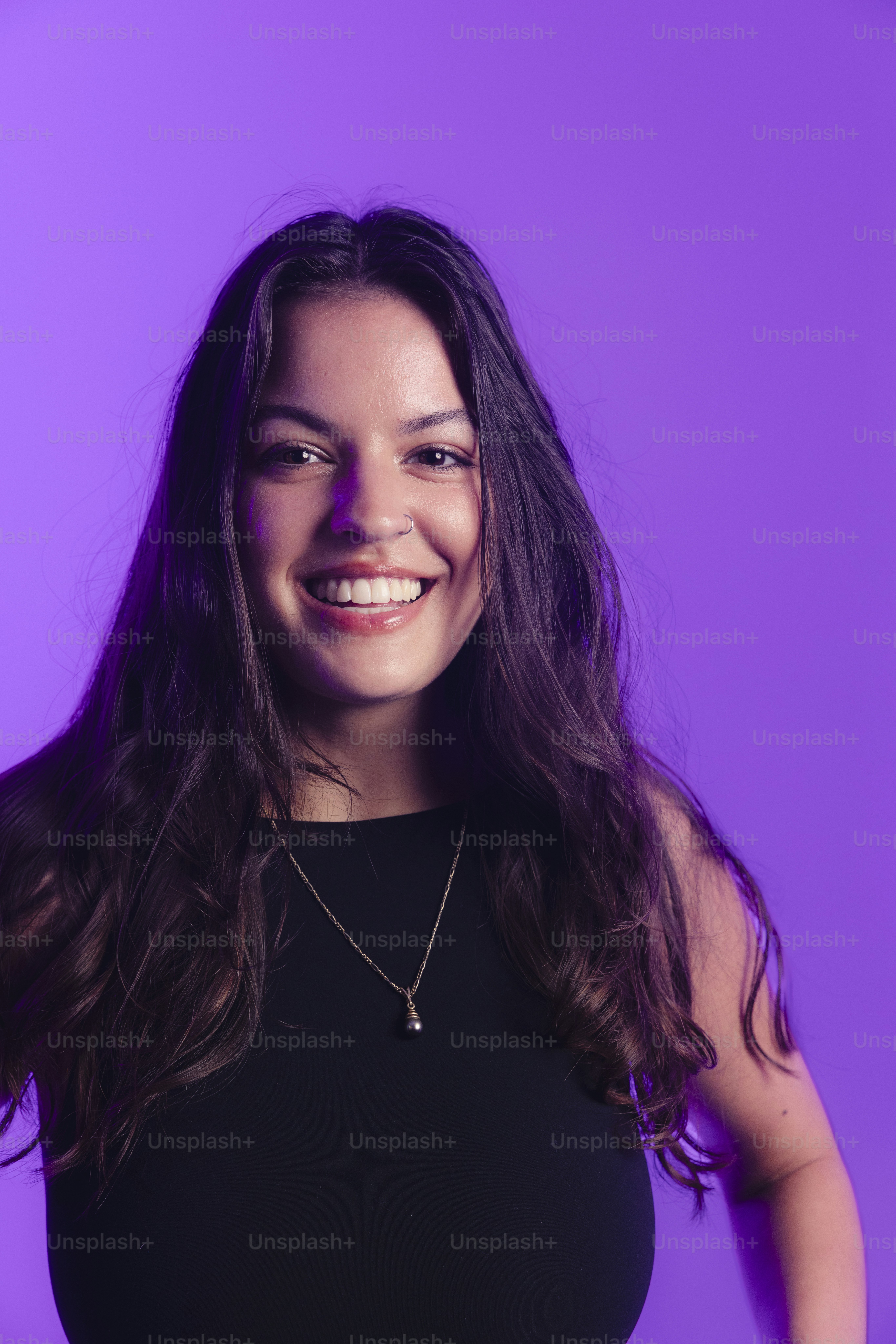 A smiling young woman with long, dark hair